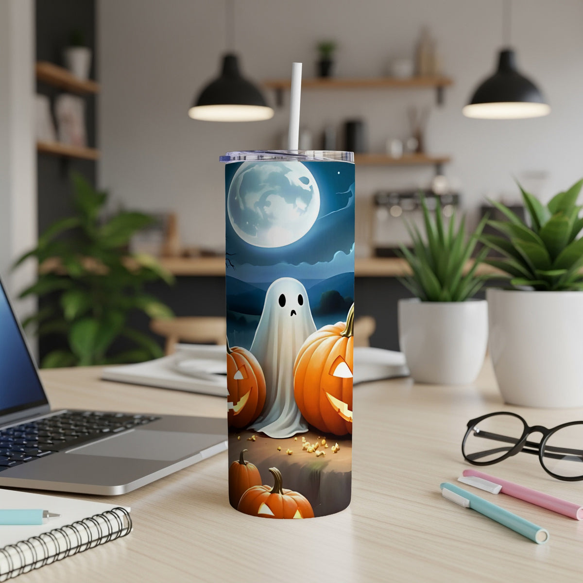 Halloween tumbler with ghost and pumpkins under a full moon.