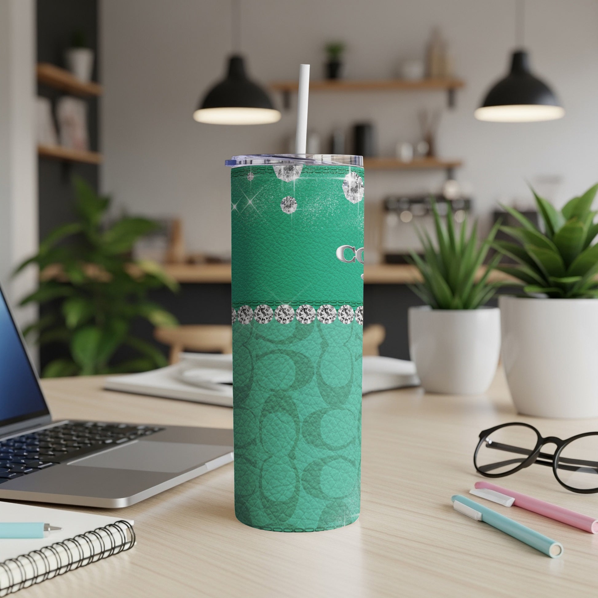 Green tumbler with diamonds and repeating logo pattern.