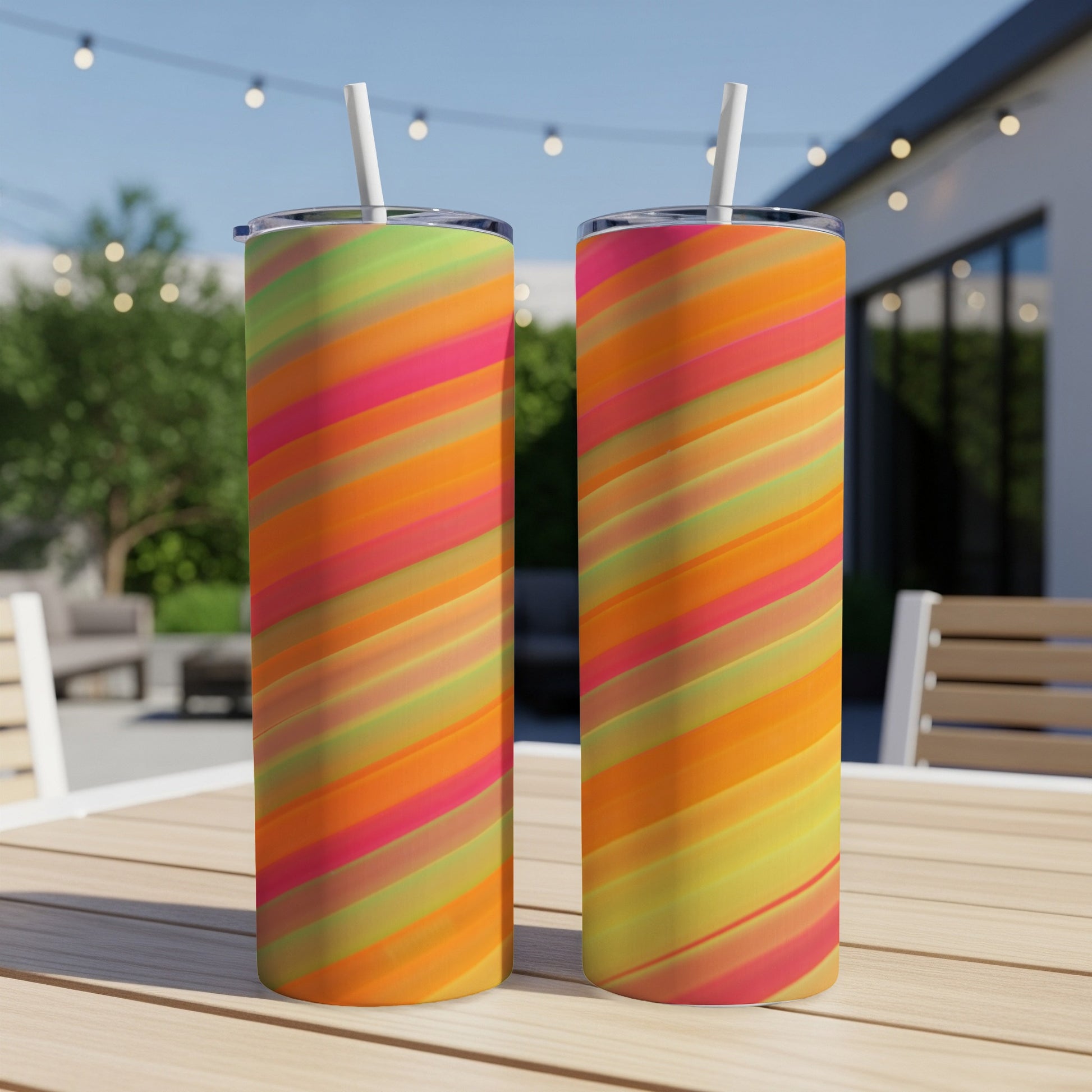 Two tall tumblers with a diagonal stripe pattern in shades of pink, orange, and yellow.