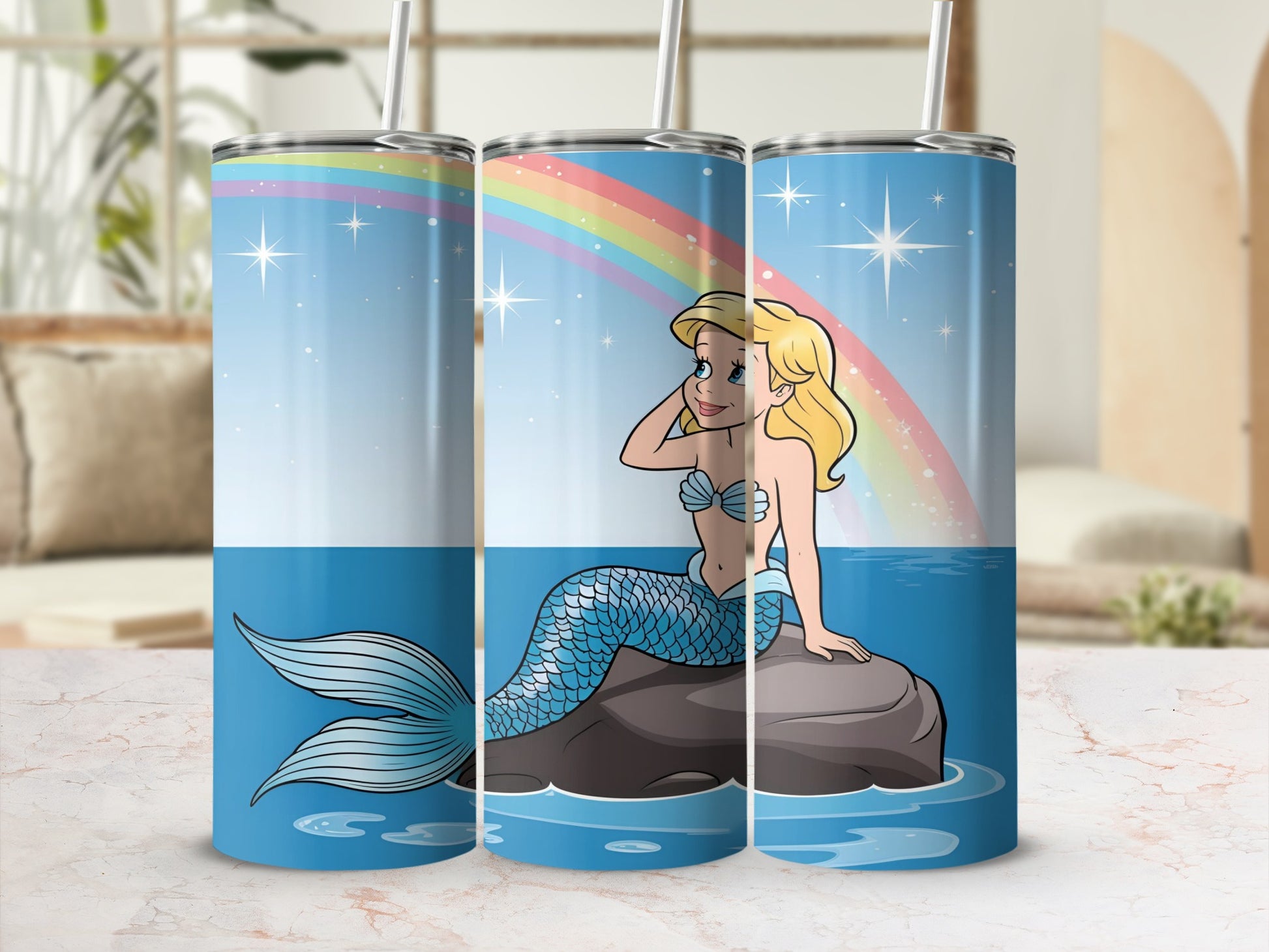 Mermaid with blue tail sitting on a rock with a rainbow.