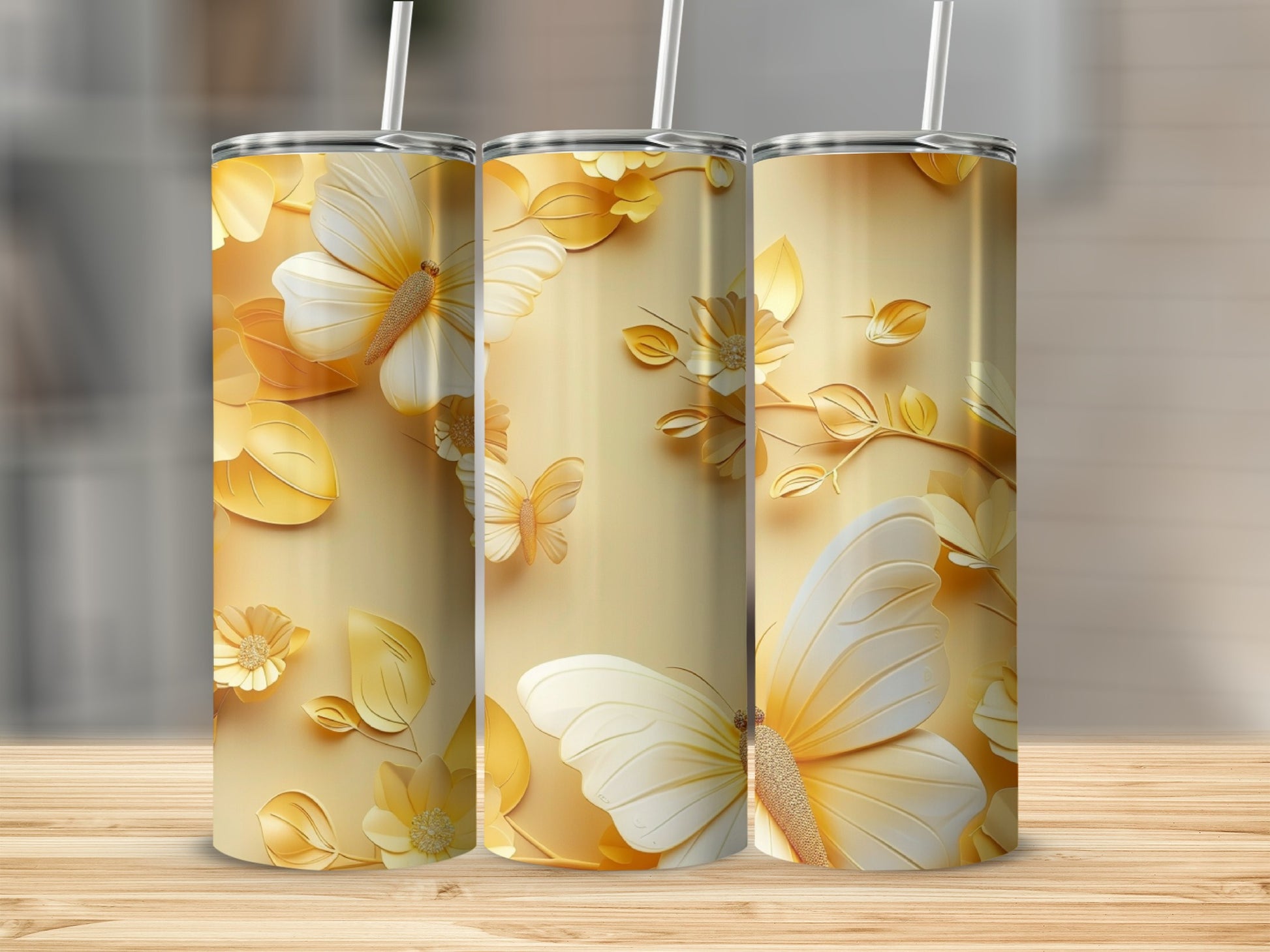 Gold tumbler with white butterflies and floral embellishments.
