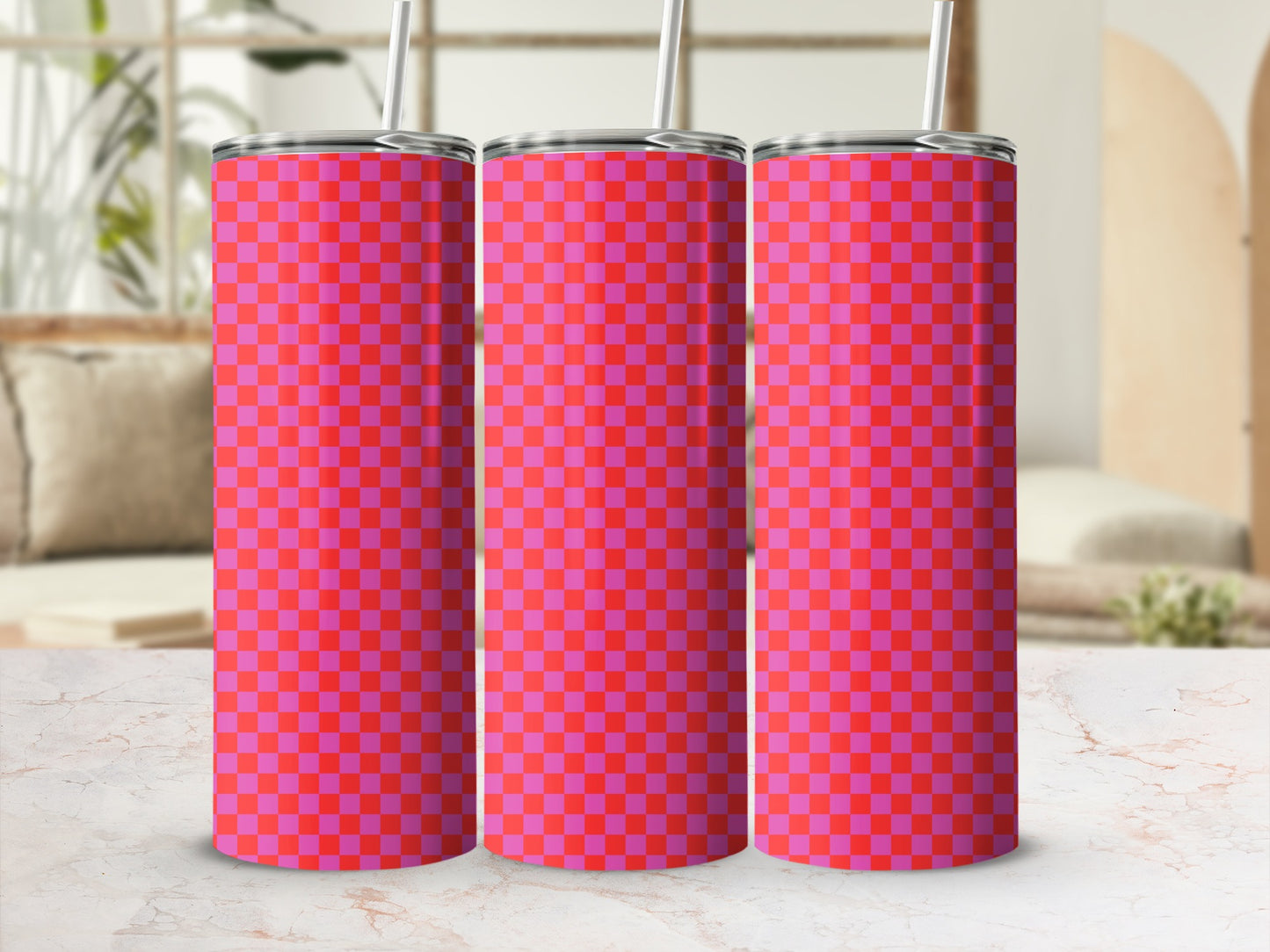 Three tall tumblers with a pink and red checkerboard pattern and straws.