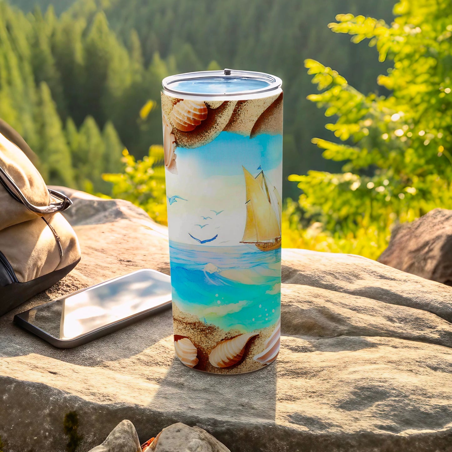 Tall tumbler with a beach and sailboat scene on a rock.