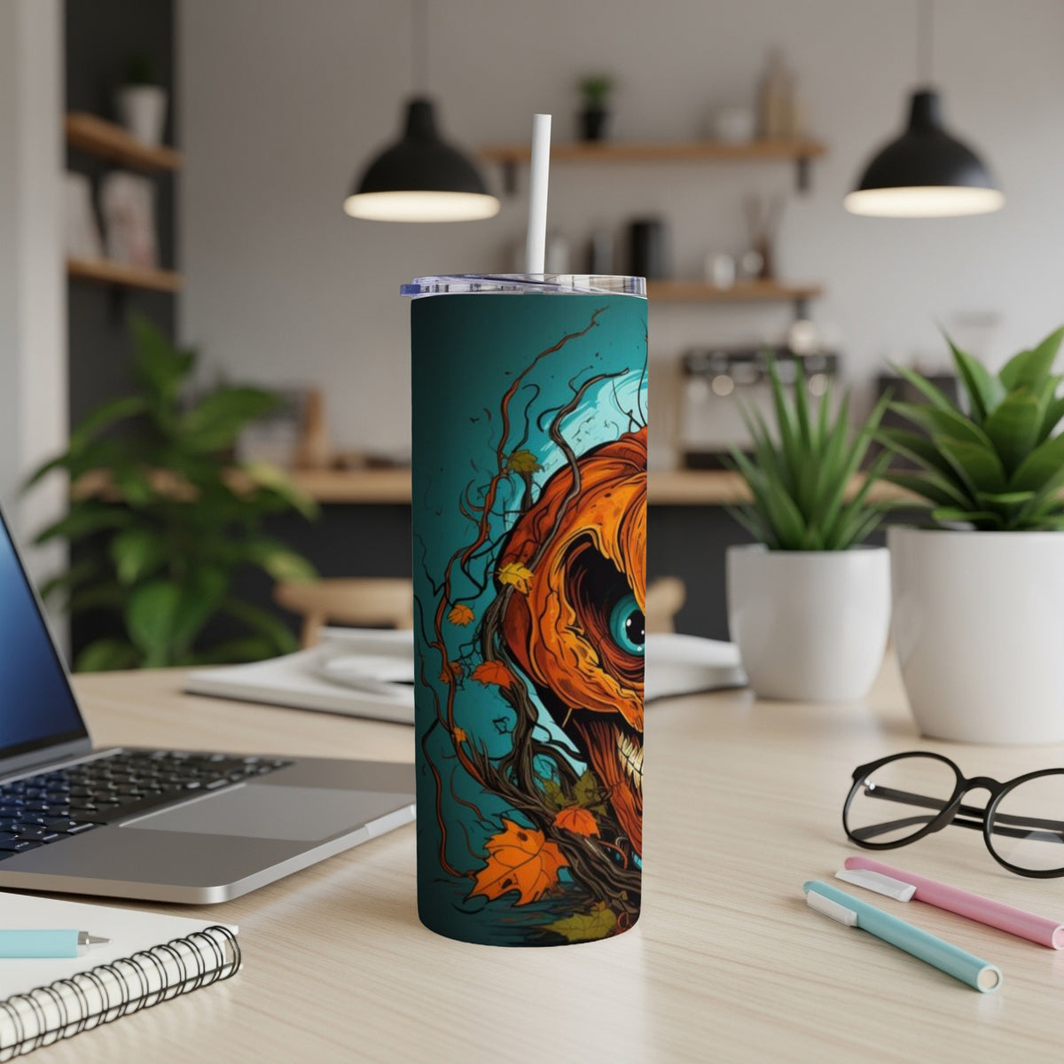 Tumbler with a creepy, stylized jack-o'-lantern design and falling autumn leaves.