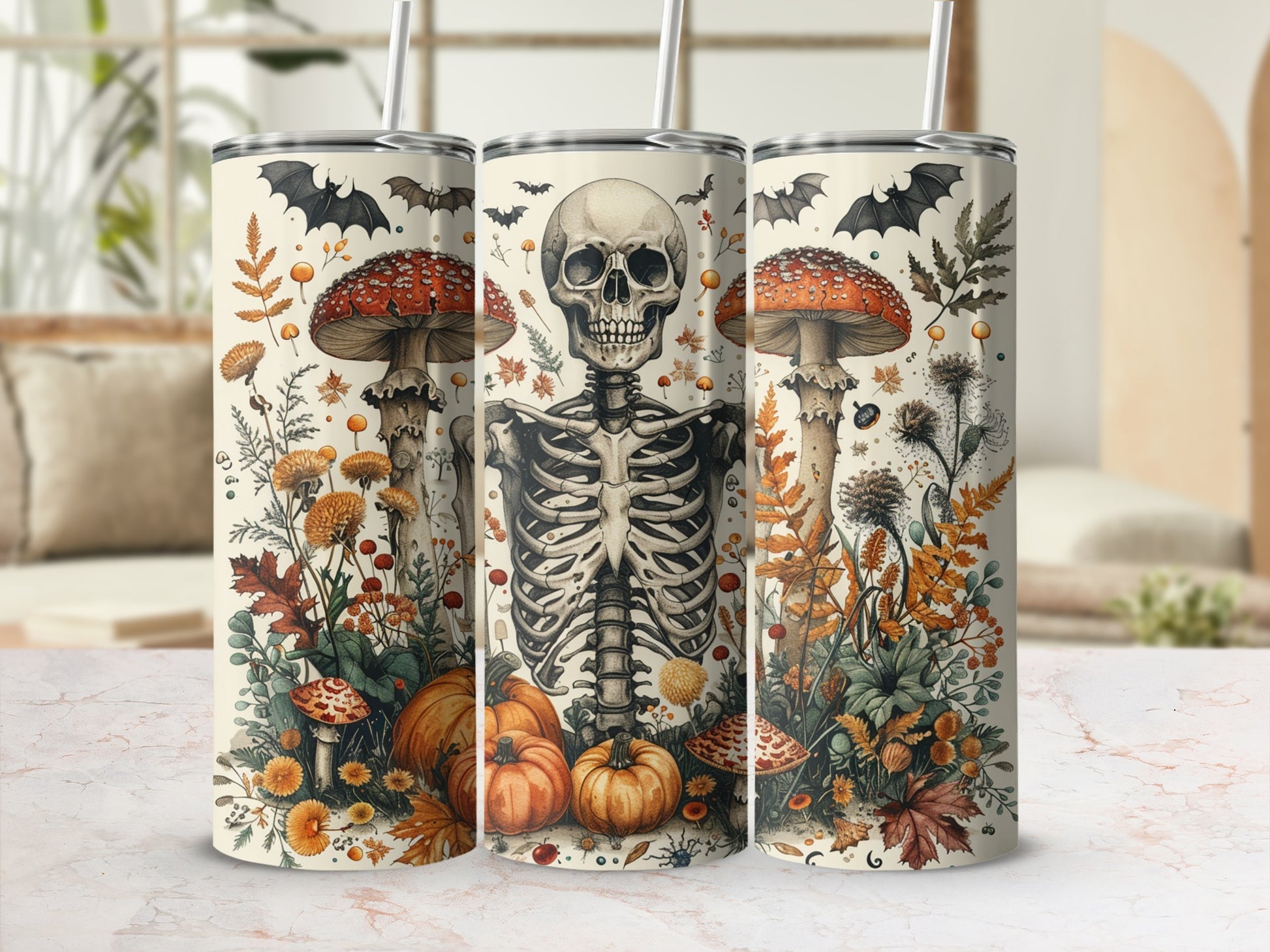 Skeleton, pumpkins, and mushrooms on cream tumblers with straws and autumn foliage.