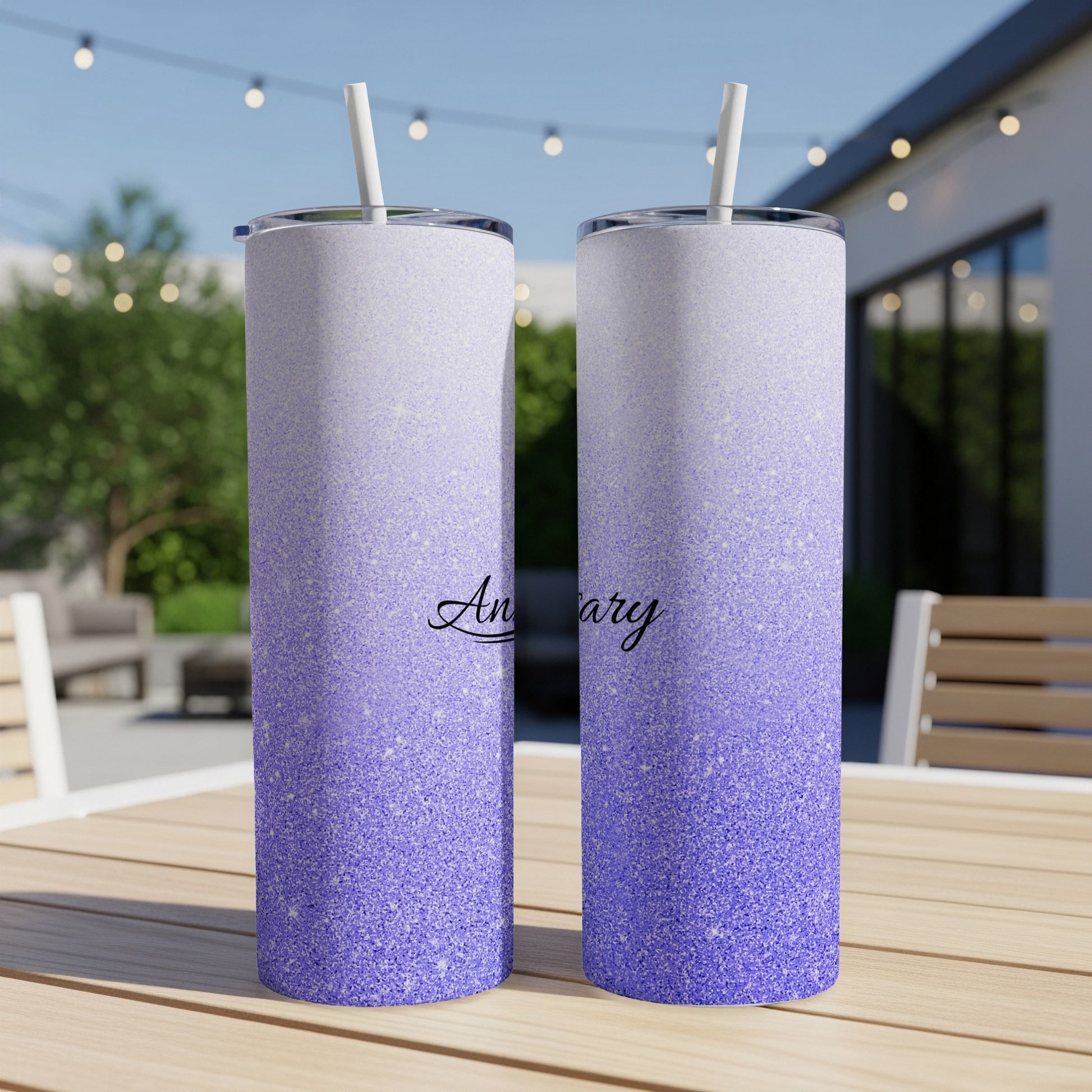 Two glittery tumblers with "Anniversary" text sit on a table.