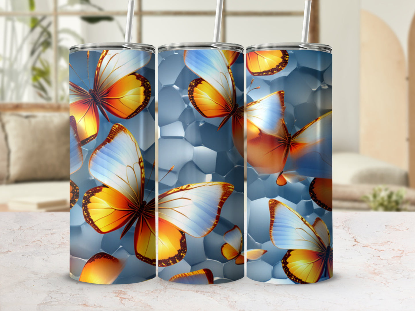 Three tumblers with a colorful butterfly design on a marbled surface.