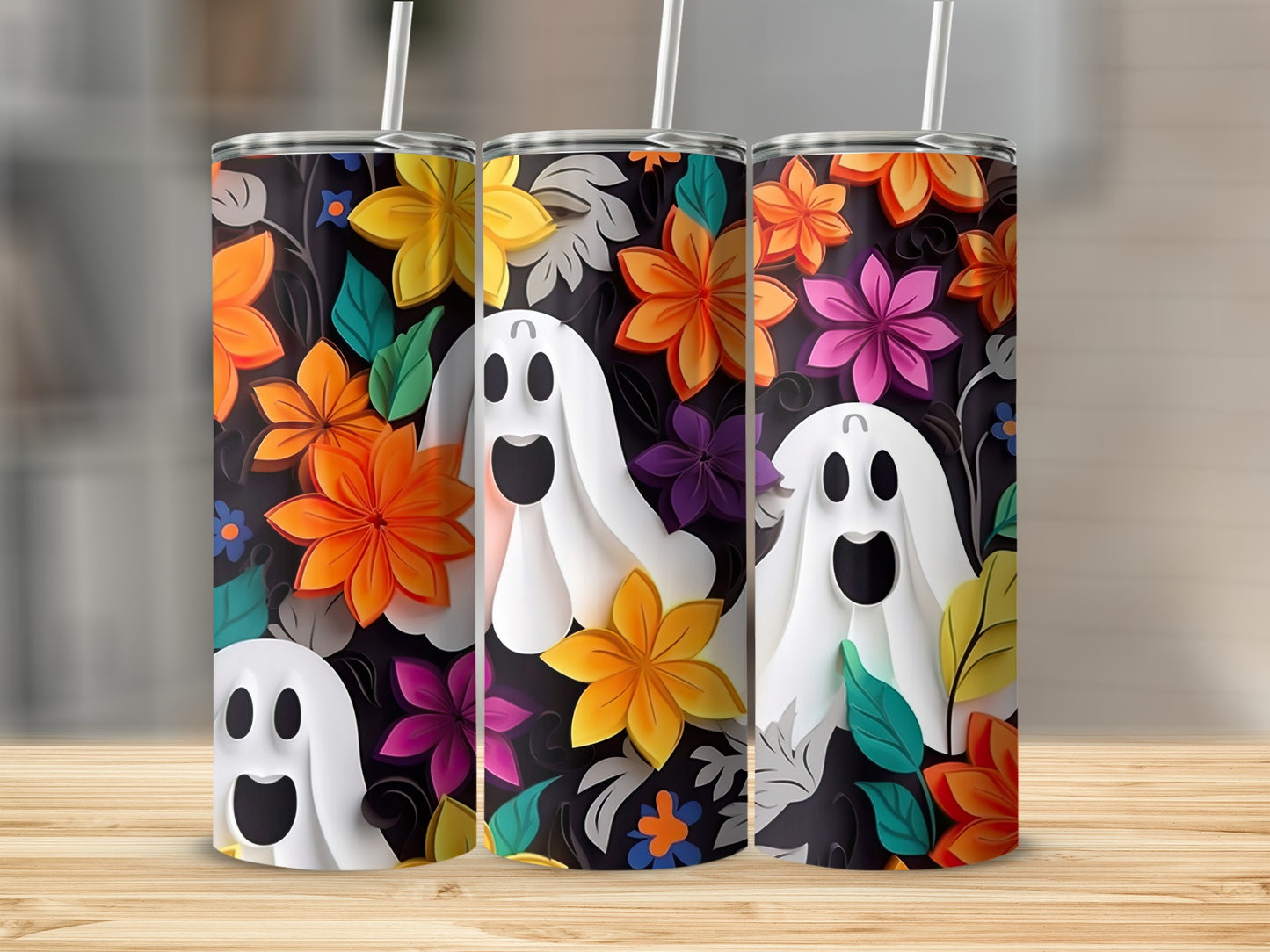 Three tumblers with a black background featuring colorful flowers and cartoon ghosts.