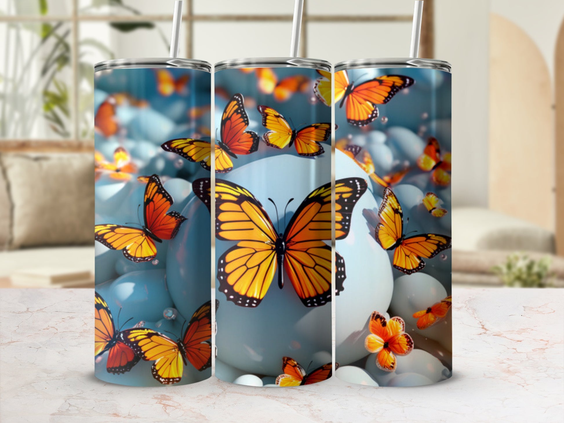 Two tall tumblers with orange butterflies and blue spheres.