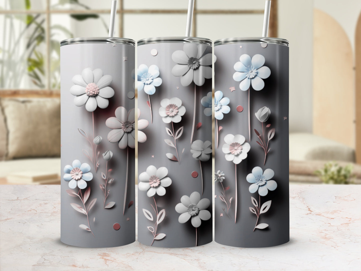 Gray tumblers with delicate white and blue floral designs and green stems.