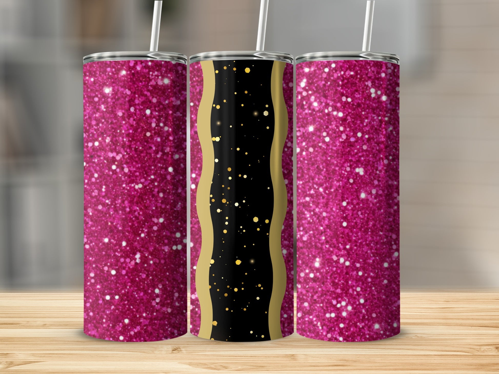Three glittery pink tumblers with gold accents on a wooden surface.