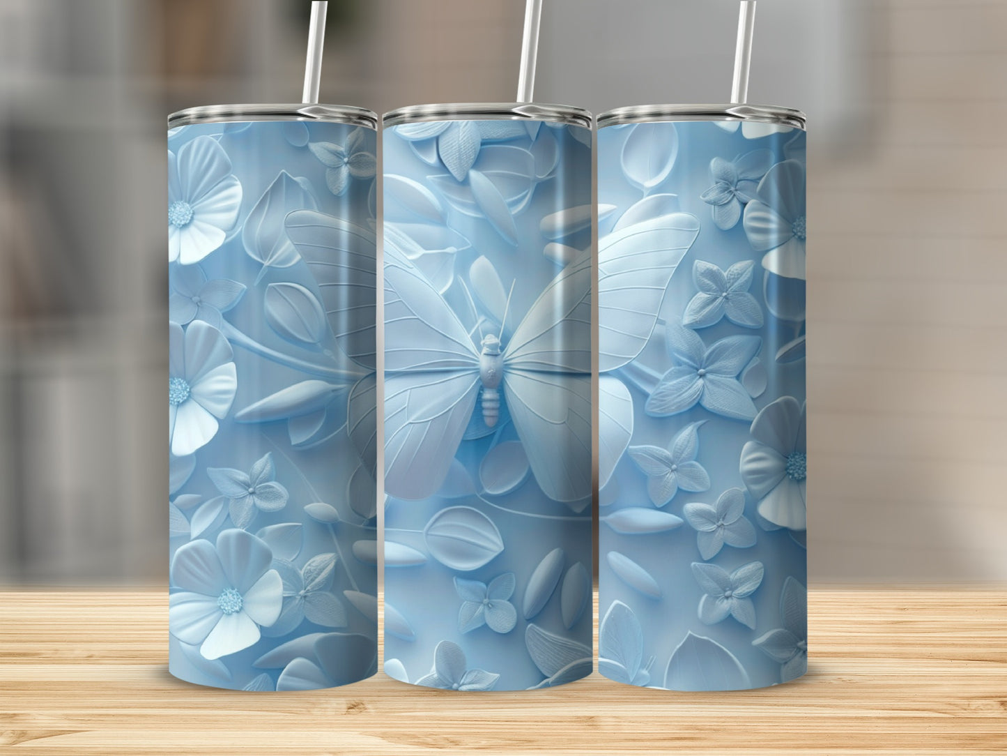 Pale blue tumbler with embossed butterflies and floral designs.