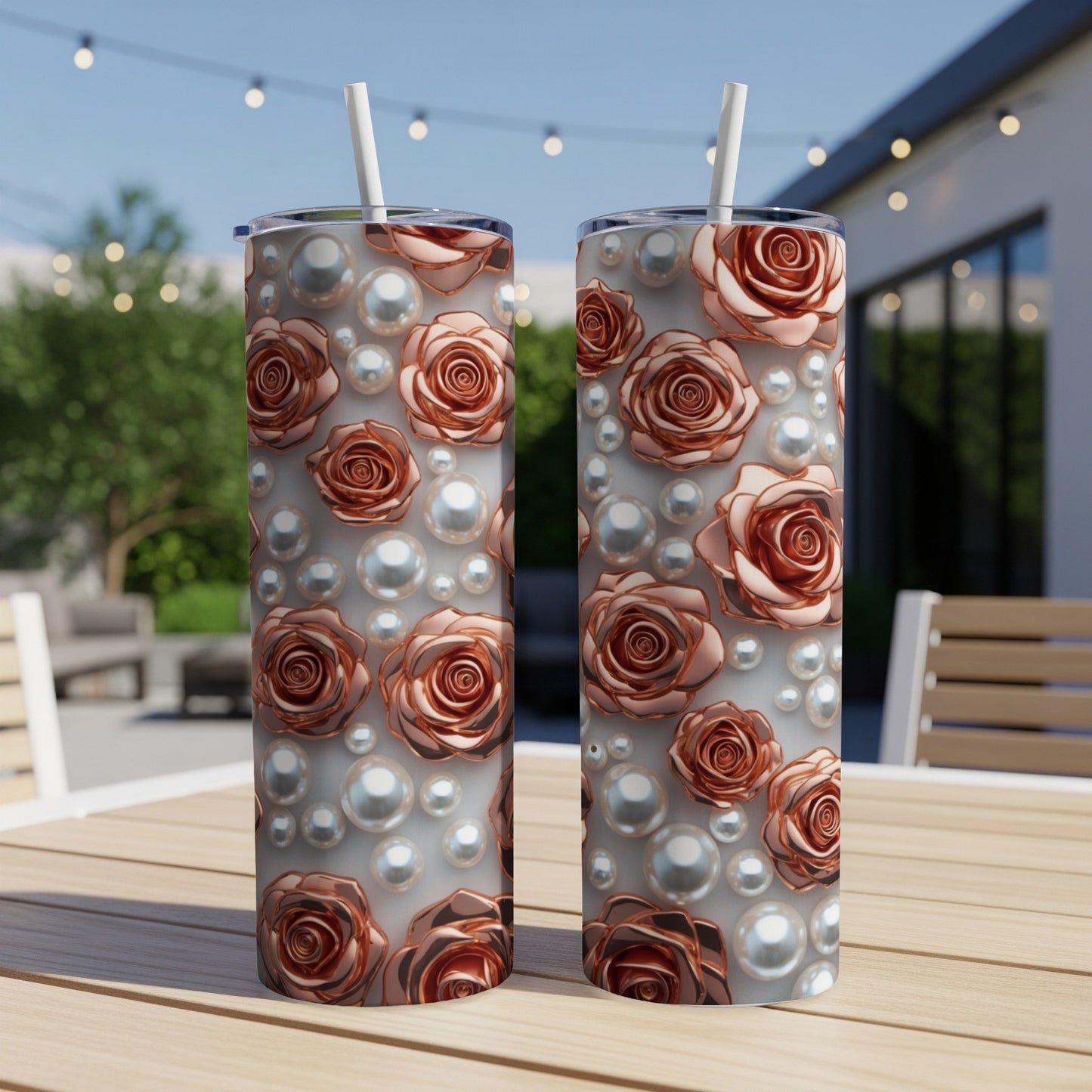 Two rose and pearl patterned tumblers on a wooden table.