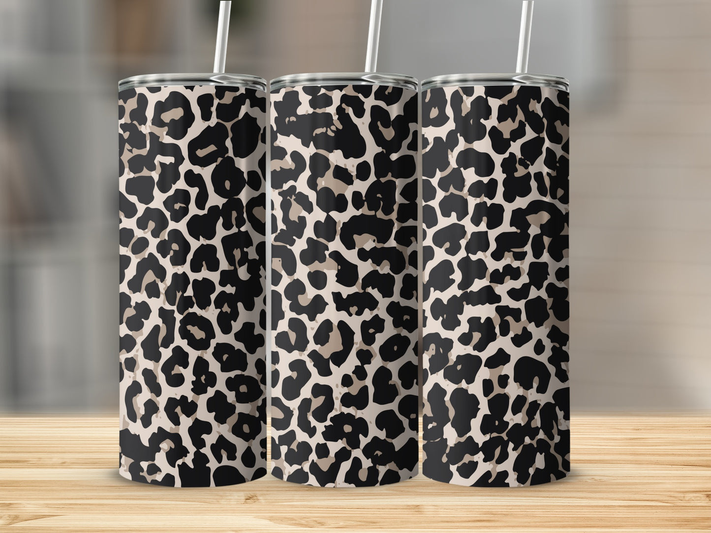 Three tumblers with a classic leopard print design and white straws.