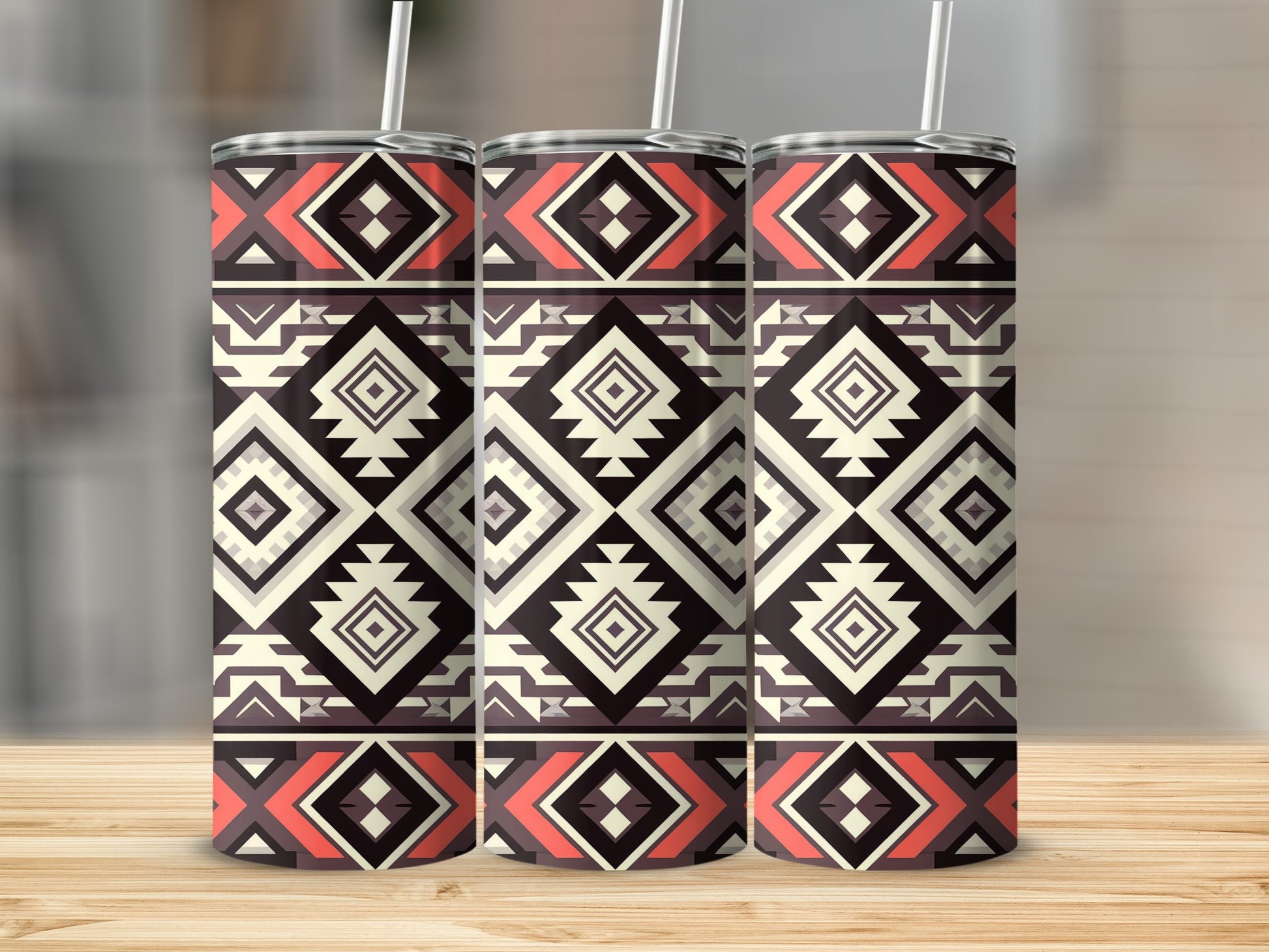Three tumblers with a geometric Southwestern pattern on a wooden surface.