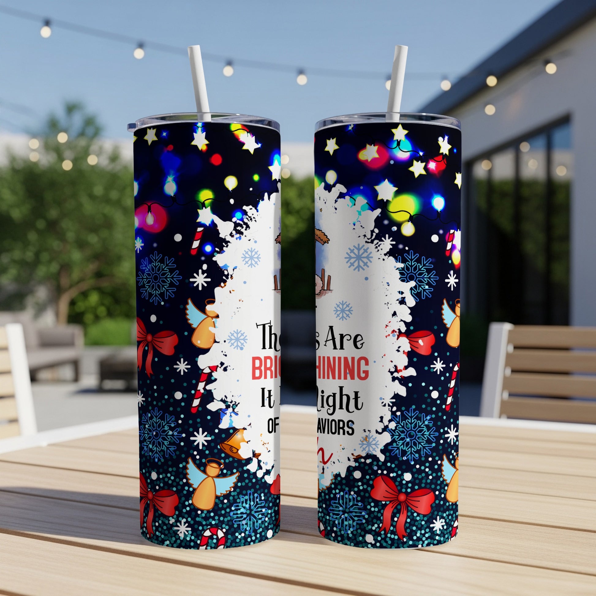 Two holiday-themed tumblers with angels, bows, snowflakes, and colorful lights.