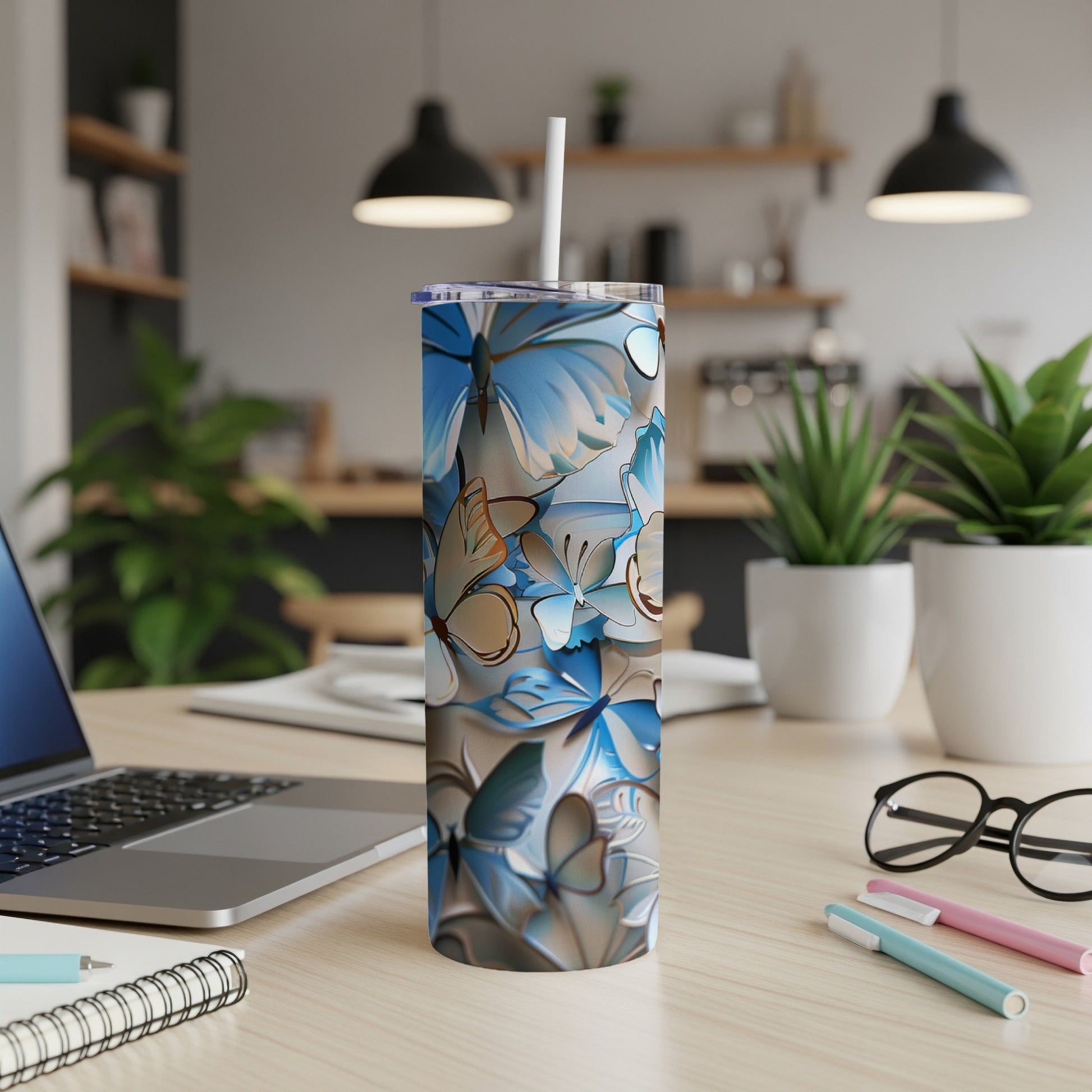Blue and tan floral butterfly pattern on a white tumbler with straw.