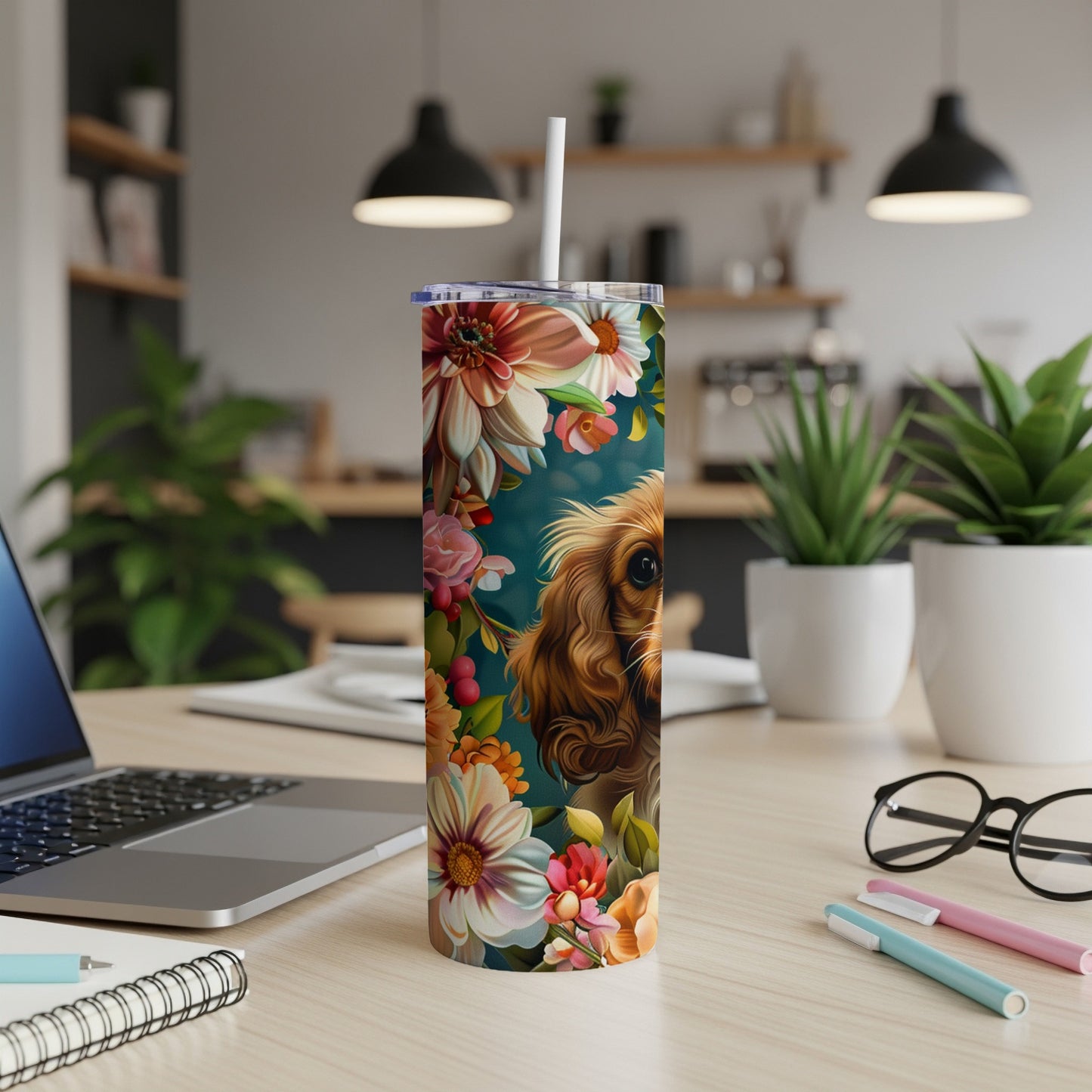 Dog and floral pattern on a stainless steel tumbler.