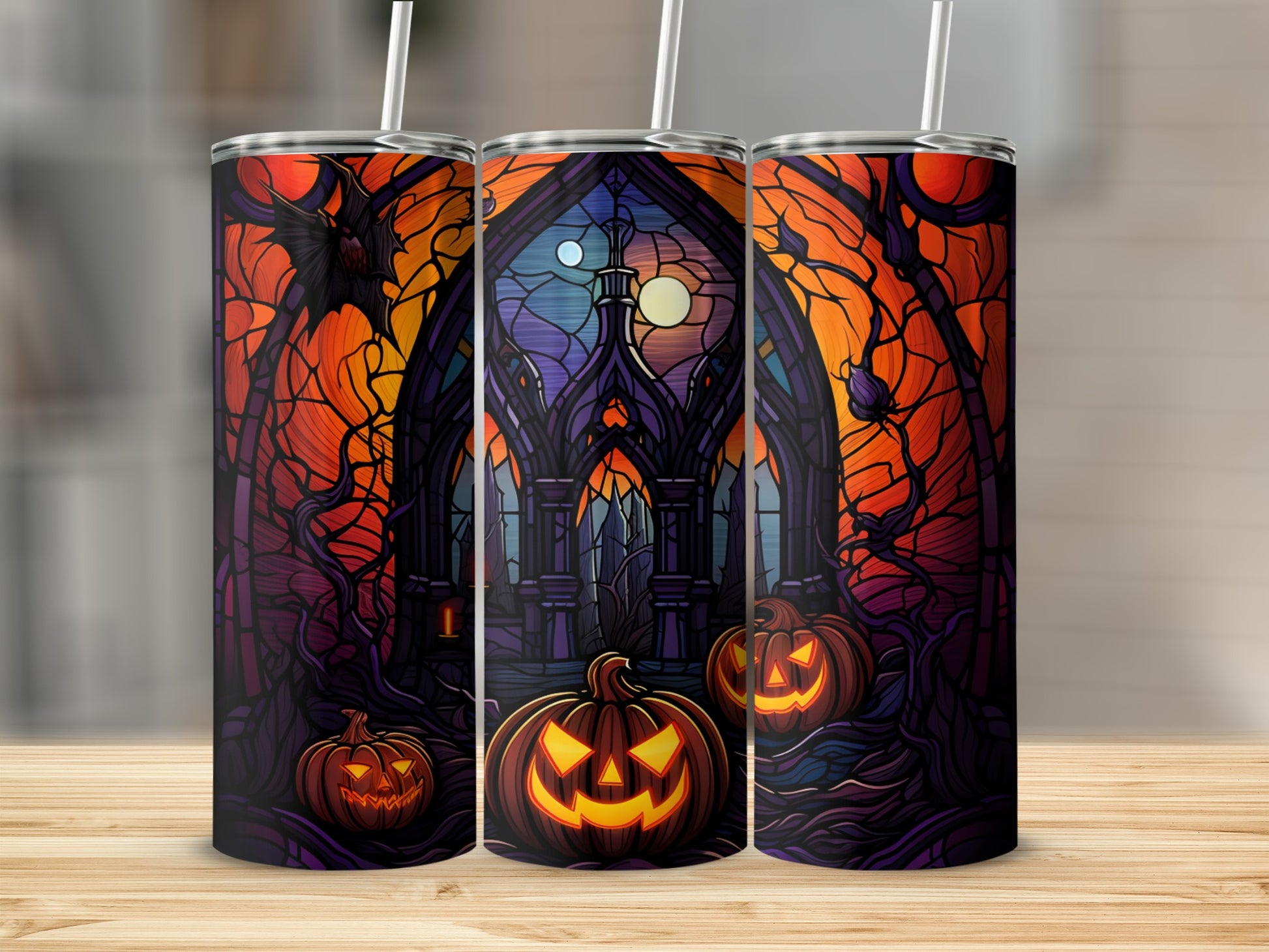 Gothic stained-glass art with pumpkins and a bat, on three tumblers.