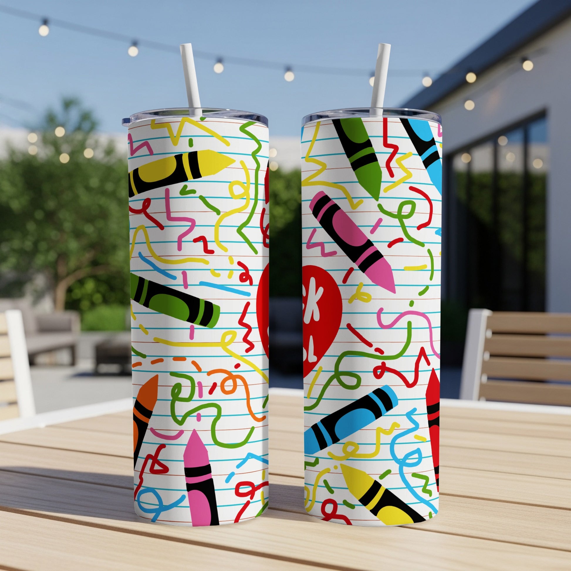 Two tumblers with a colorful crayon and confetti pattern on a ruled notebook paper background.