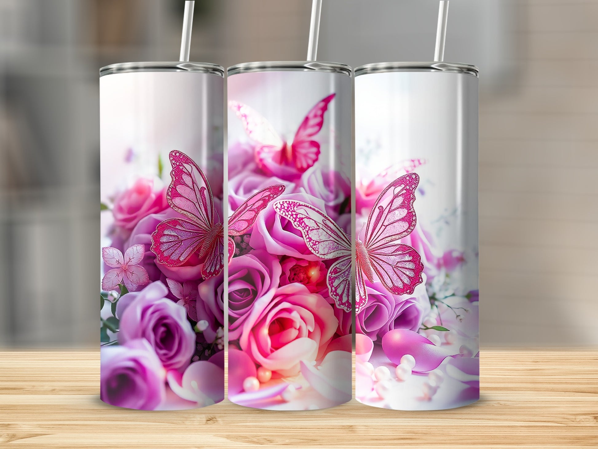 Three tumblers with a pink butterfly and rose floral design.