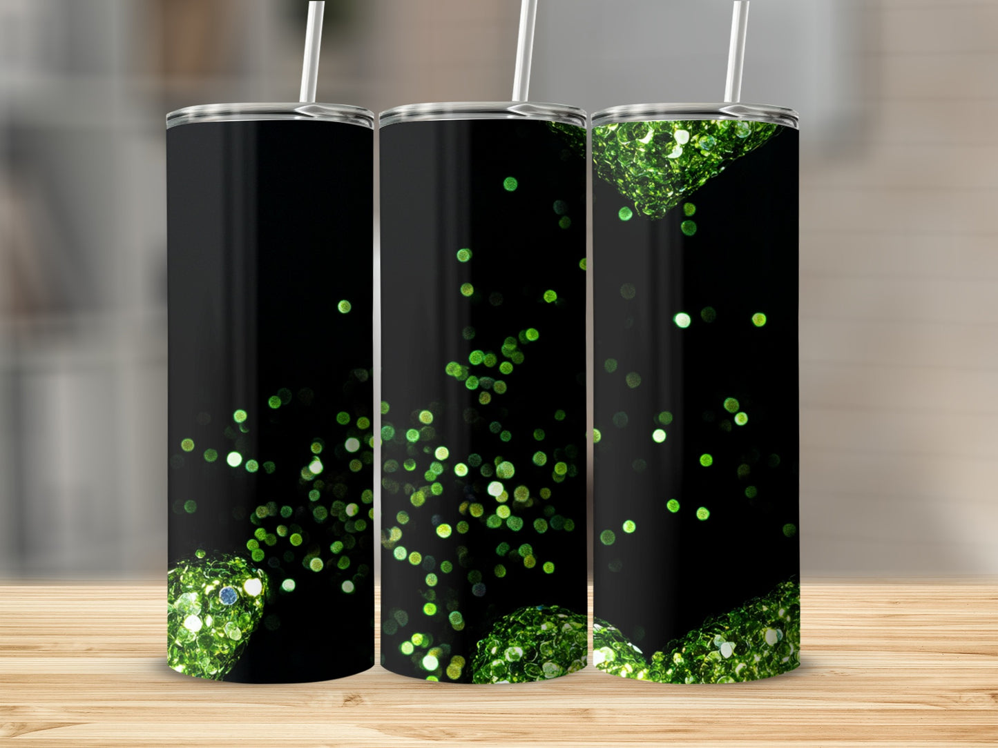 Black tumbler with scattered green glitter accents and straw.