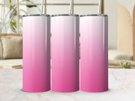 Three pink gradient tumblers with straws stand on a marble surface.