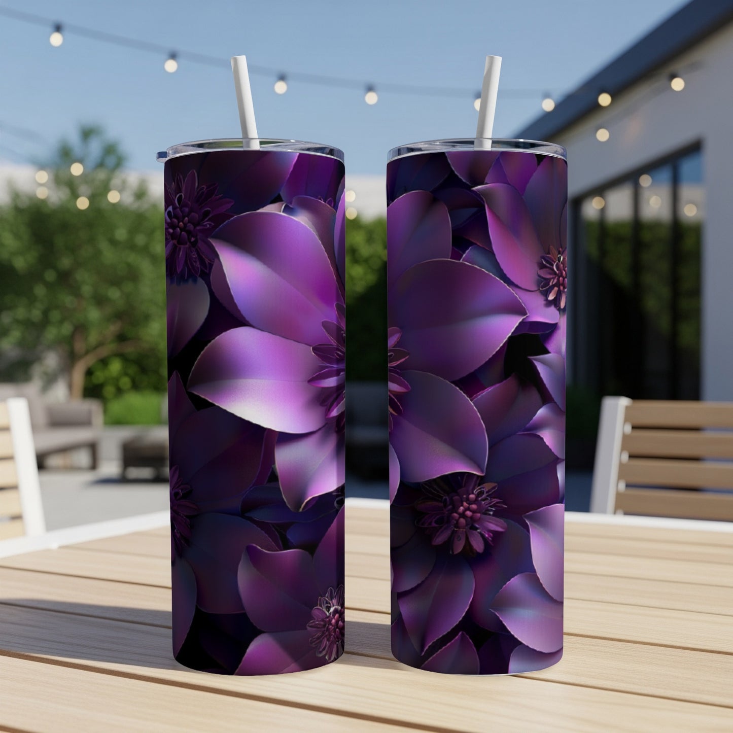 Two purple floral tumblers with straws on a table.
