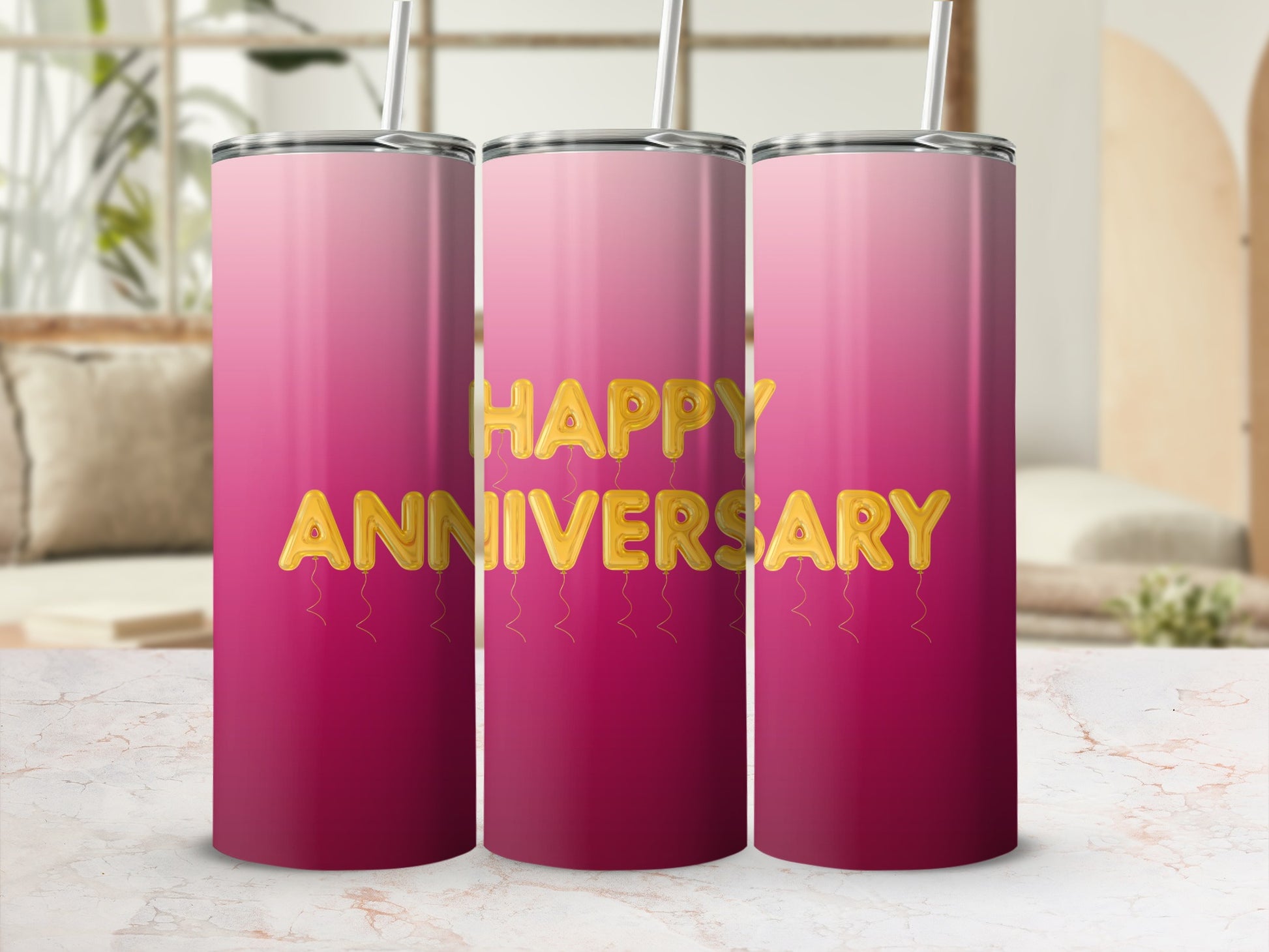 Three pink gradient tumblers with gold balloon letters spelling "Happy Anniversary".