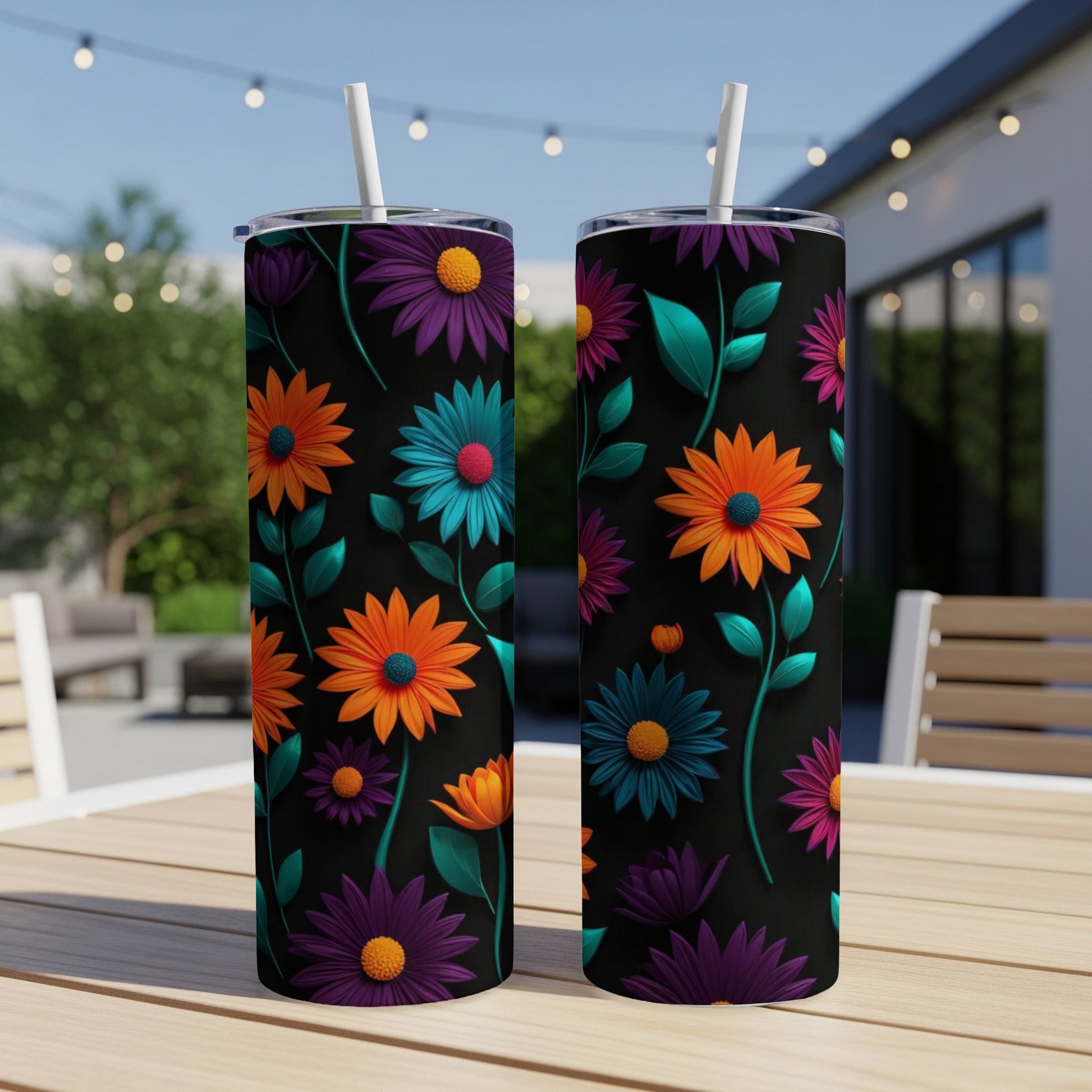 Two black tumblers with a colorful floral pattern featuring orange, purple, and teal flowers.