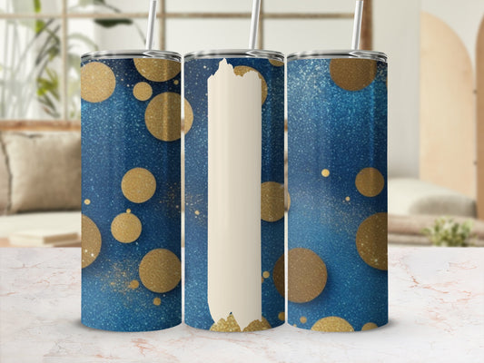 Three blue and gold glitter dot tumblers with straws displayed on a marble surface.