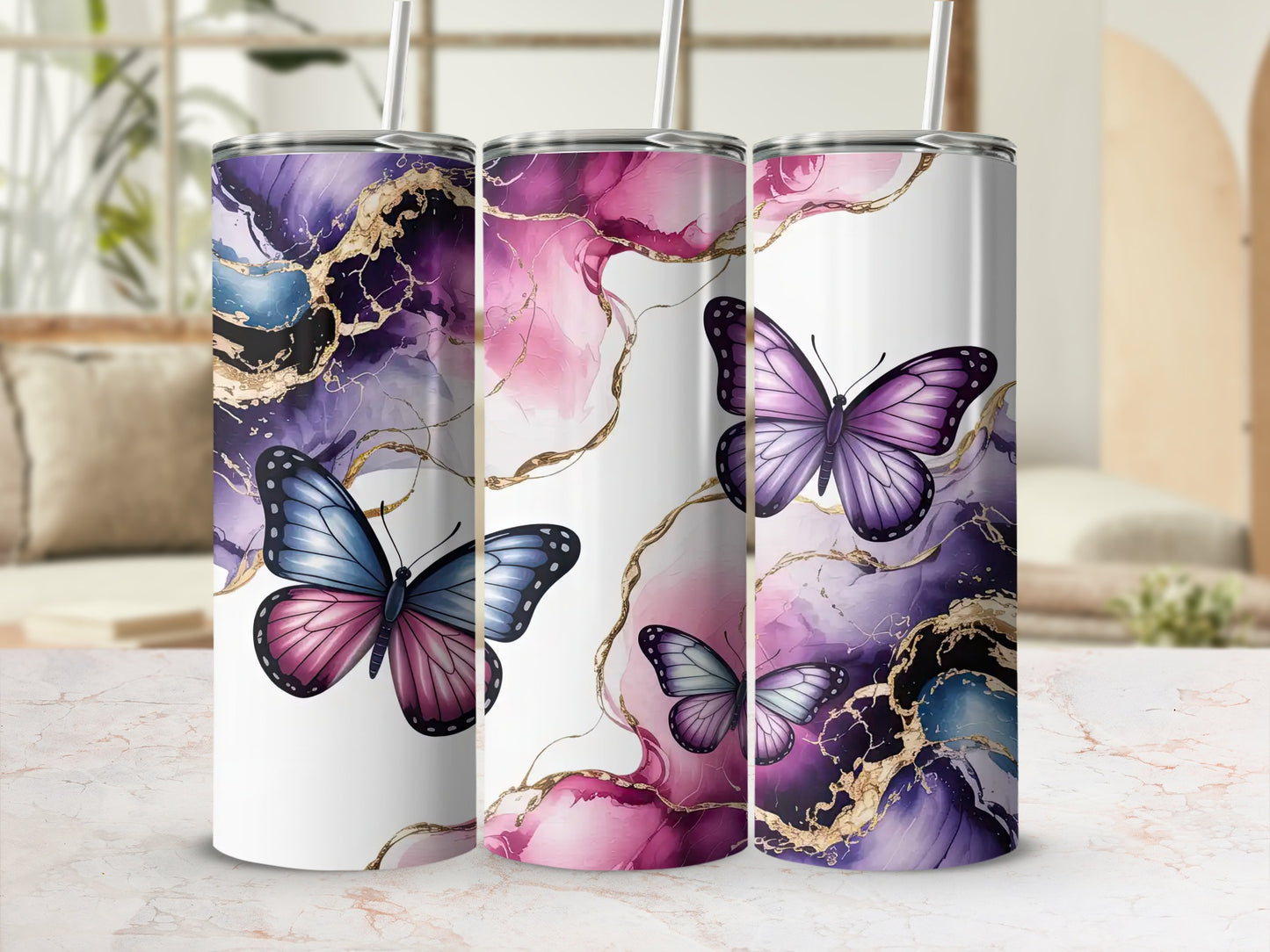 Three tumblers with purple and blue butterfly and marble designs.