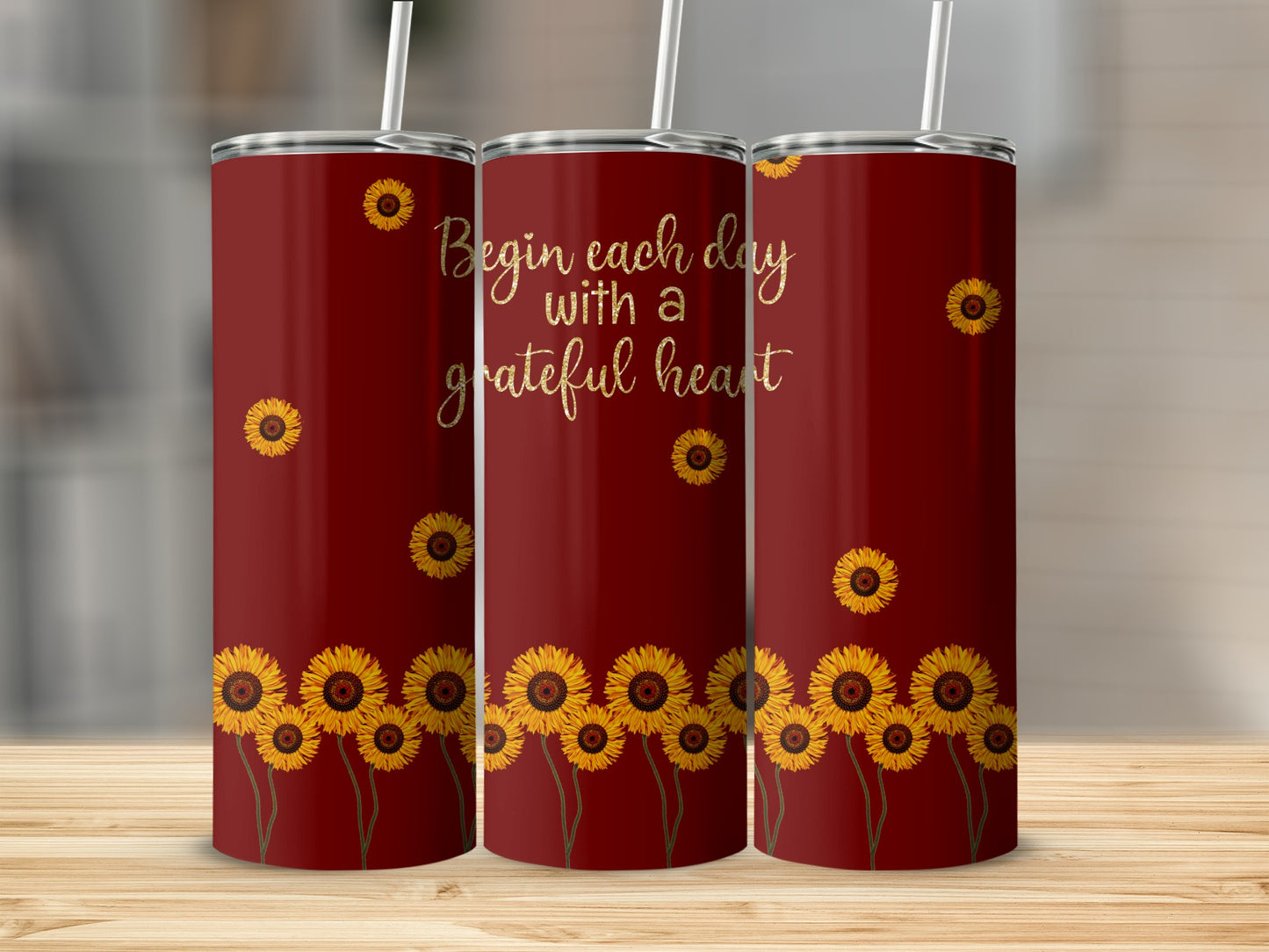 Maroon tumbler with sunflowers and text "Begin each day with a grateful heart".