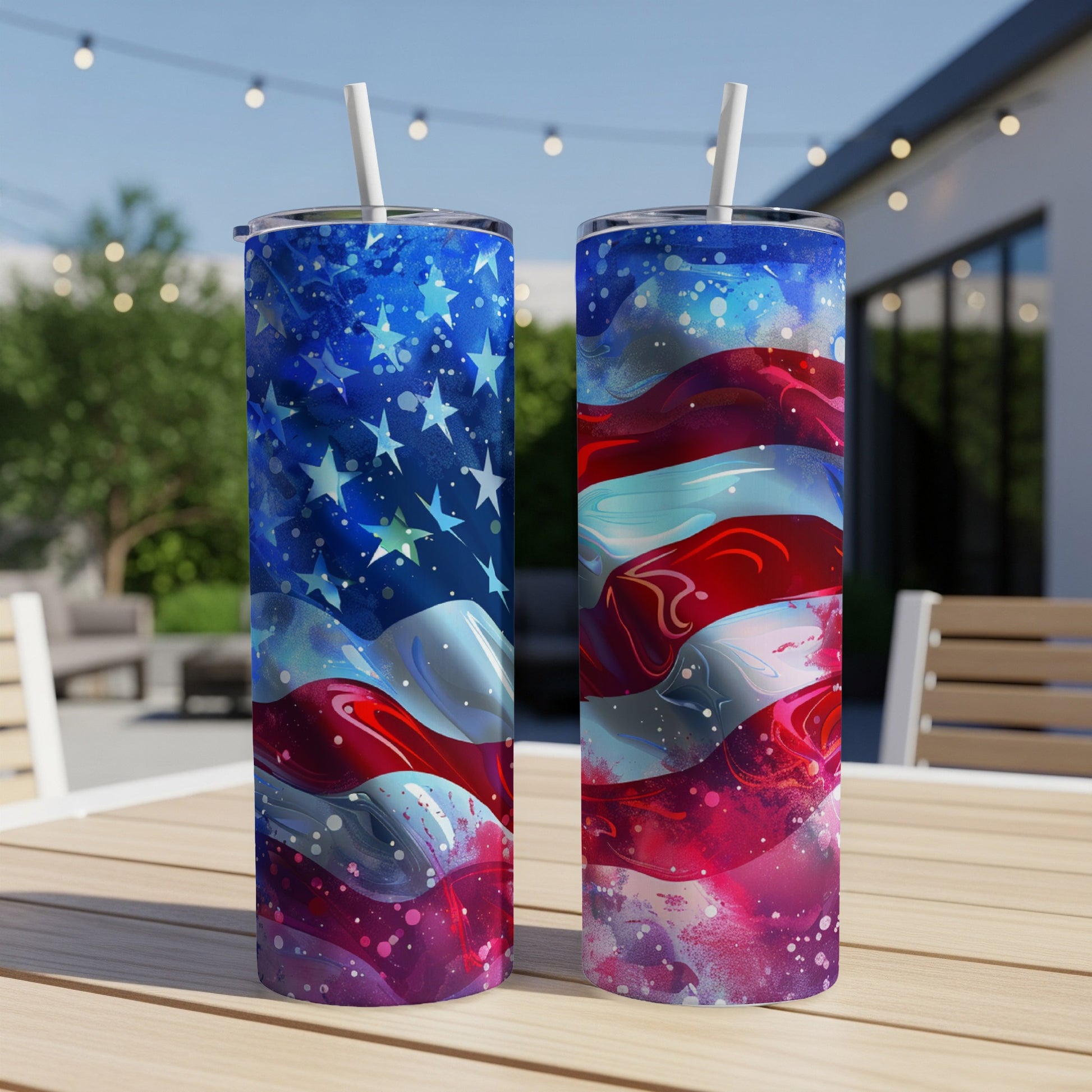 Two tumblers with American flag design on outdoor table.
