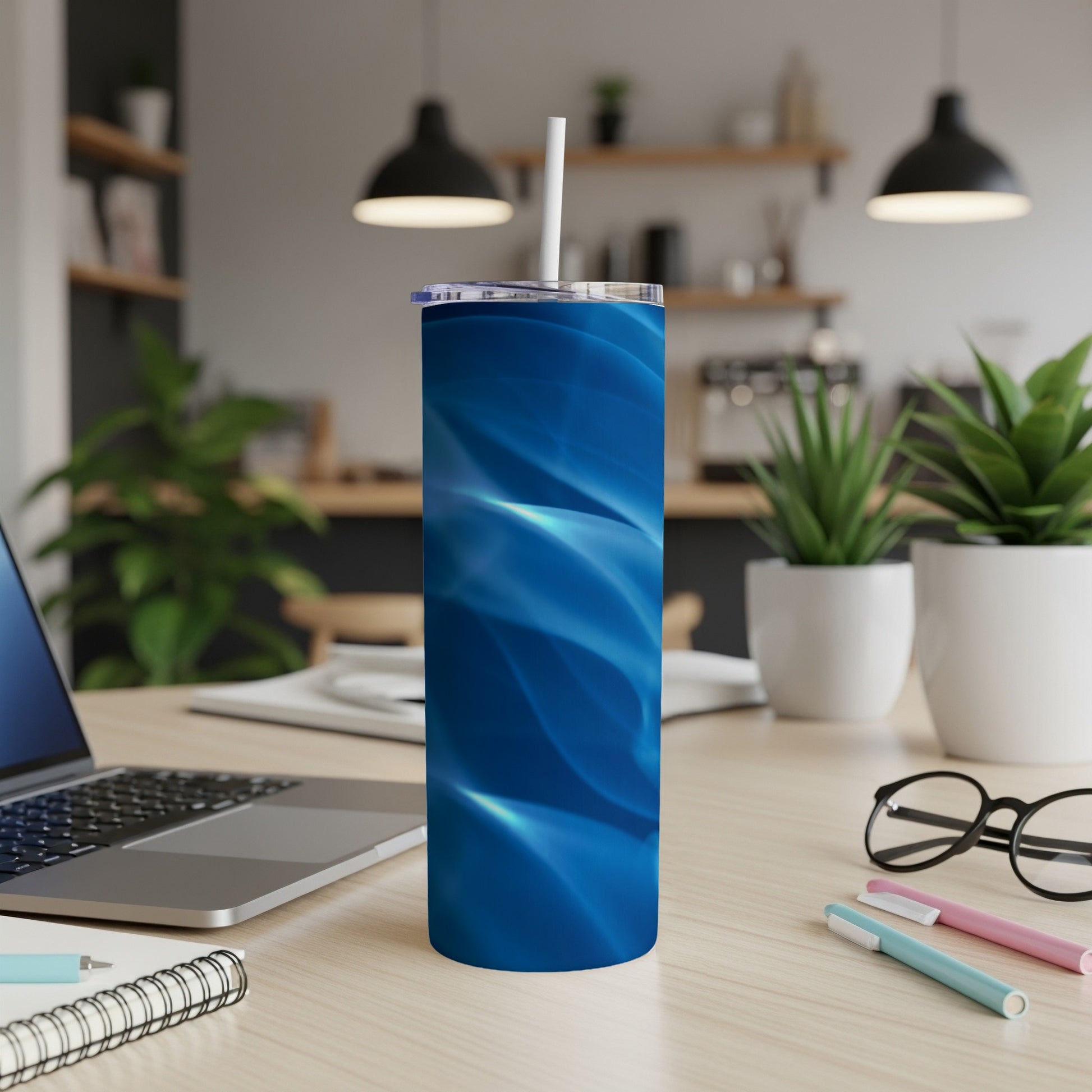 Blue abstract pattern on a stainless steel tumbler with straw.