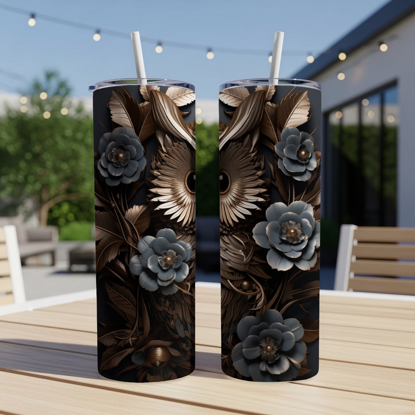 Two dark tumblers with metallic owl and floral designs on a wooden table.