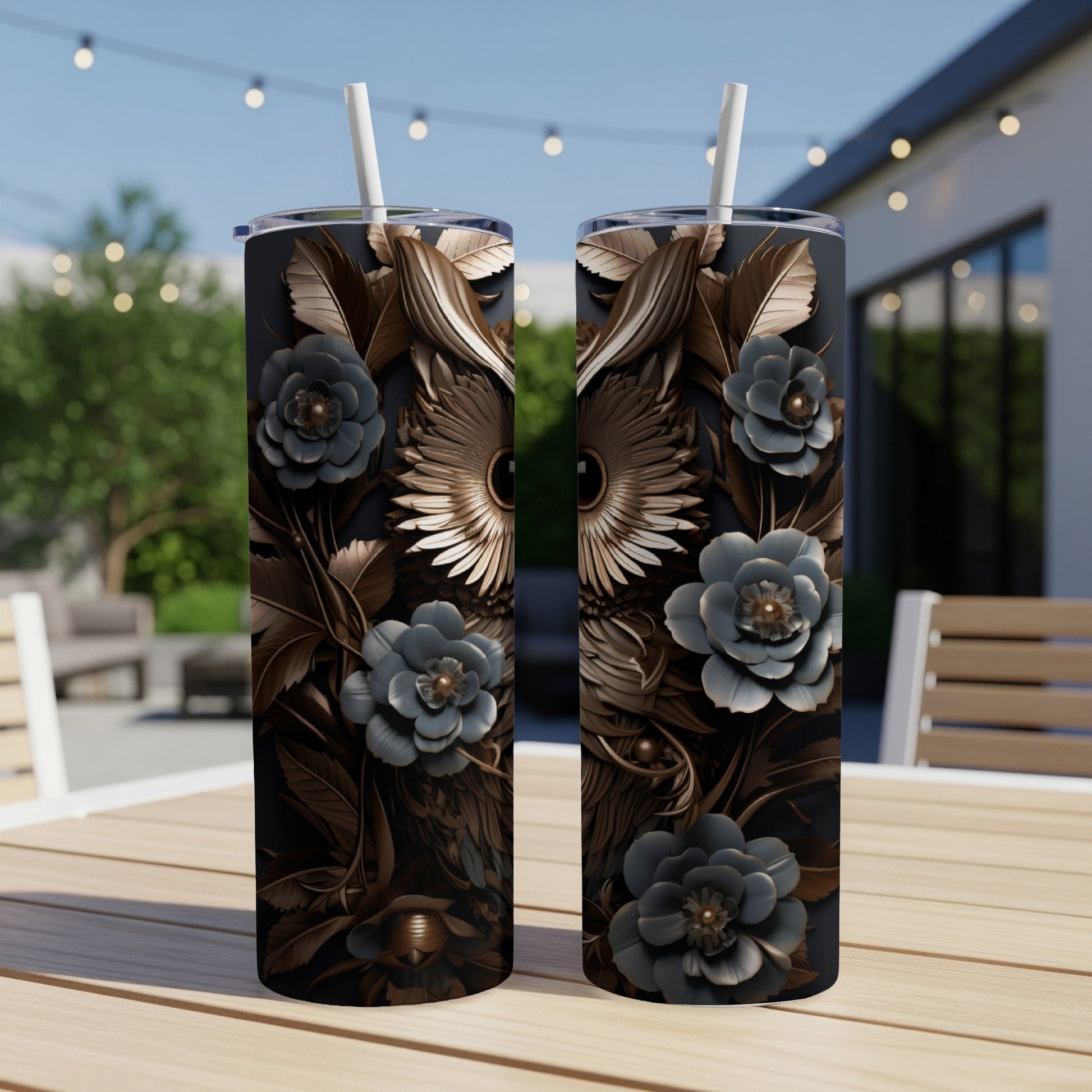 Two dark tumblers with metallic owl and floral designs on a wooden table.