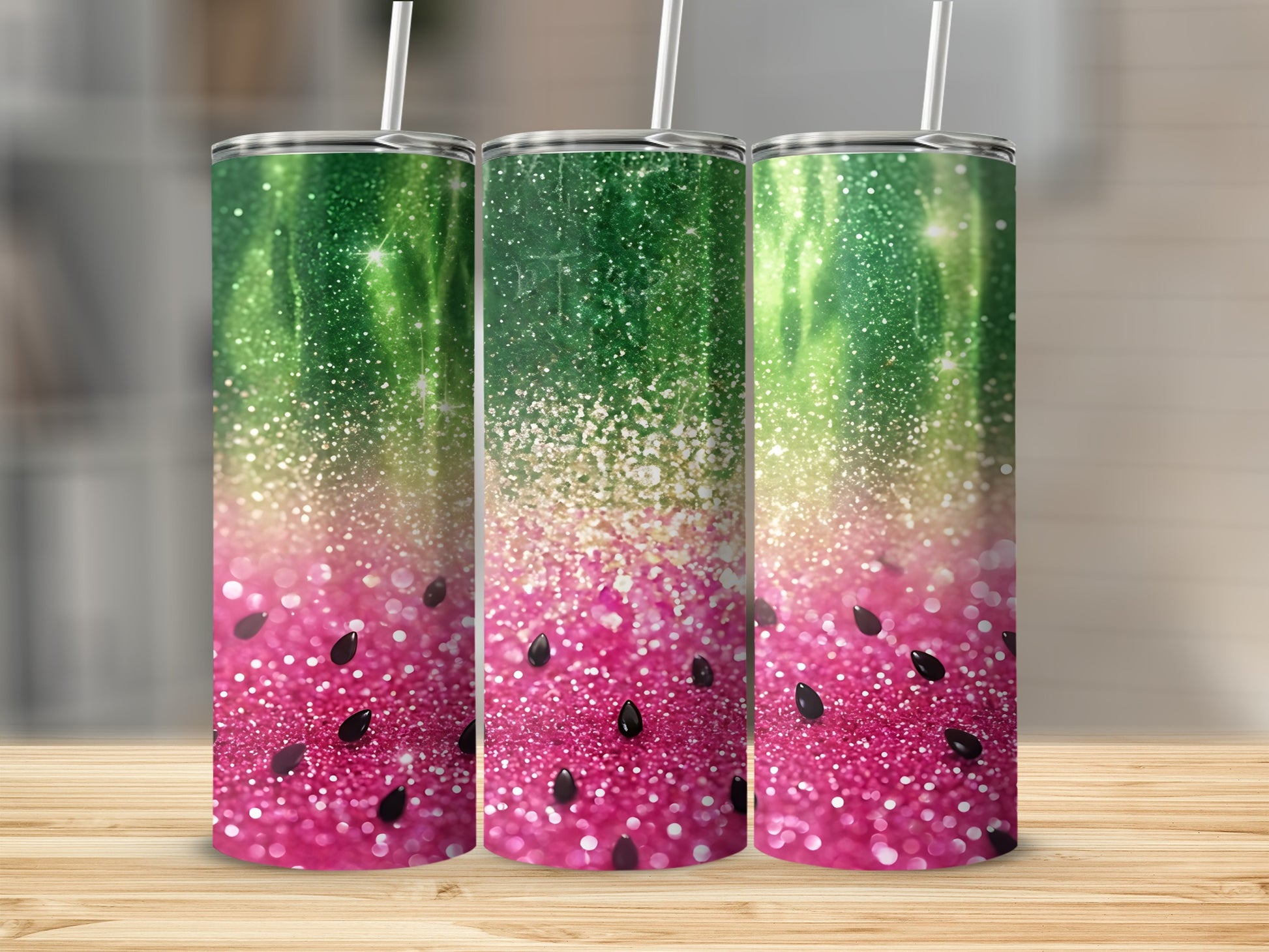 Three tumblers with a watermelon and glitter design on a wooden surface.