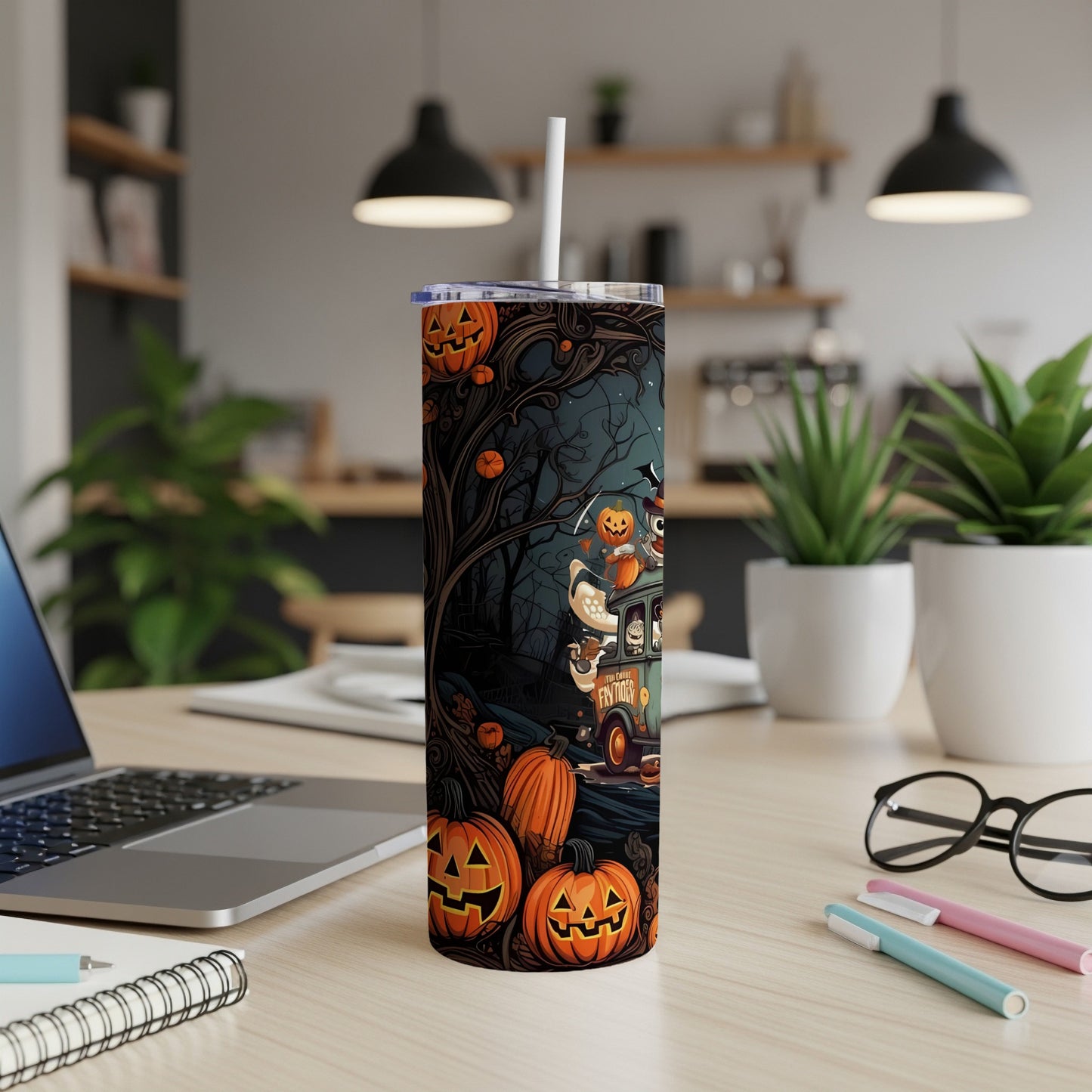 Tall tumbler with Halloween-themed art featuring pumpkins and a spooky forest scene.
