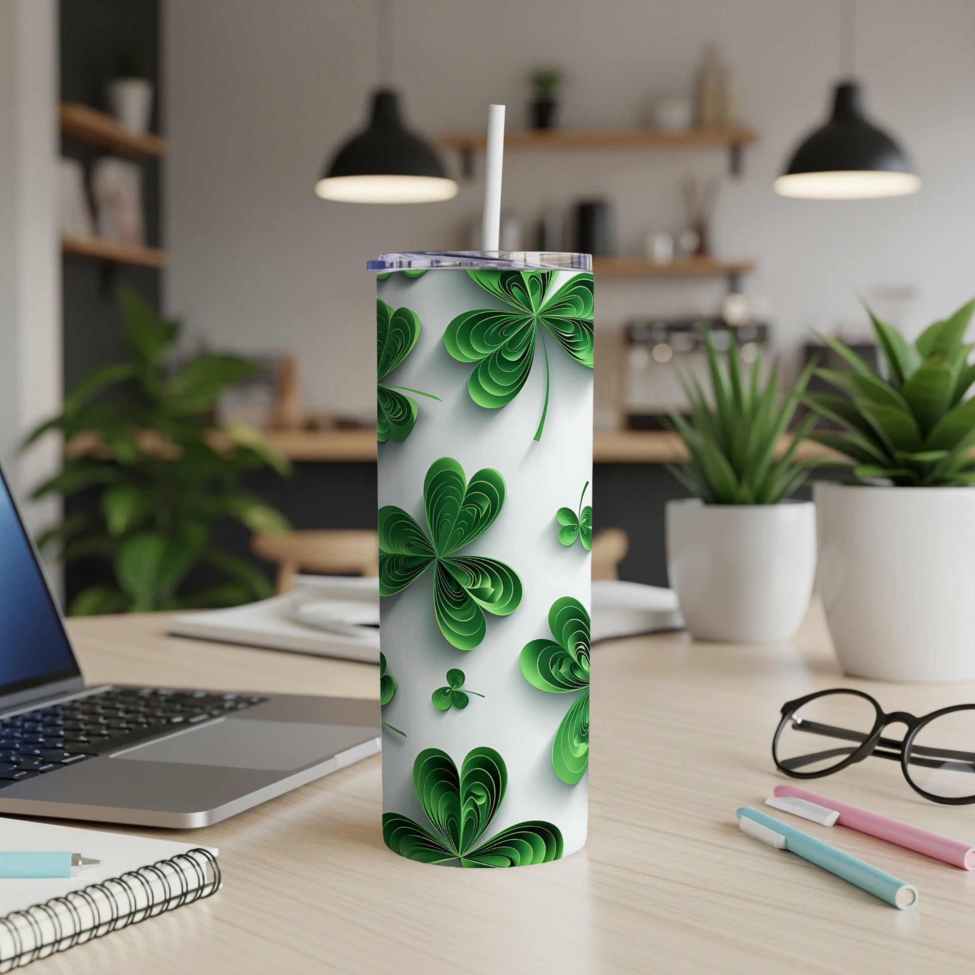 White tumbler with green shamrock design and white straw.