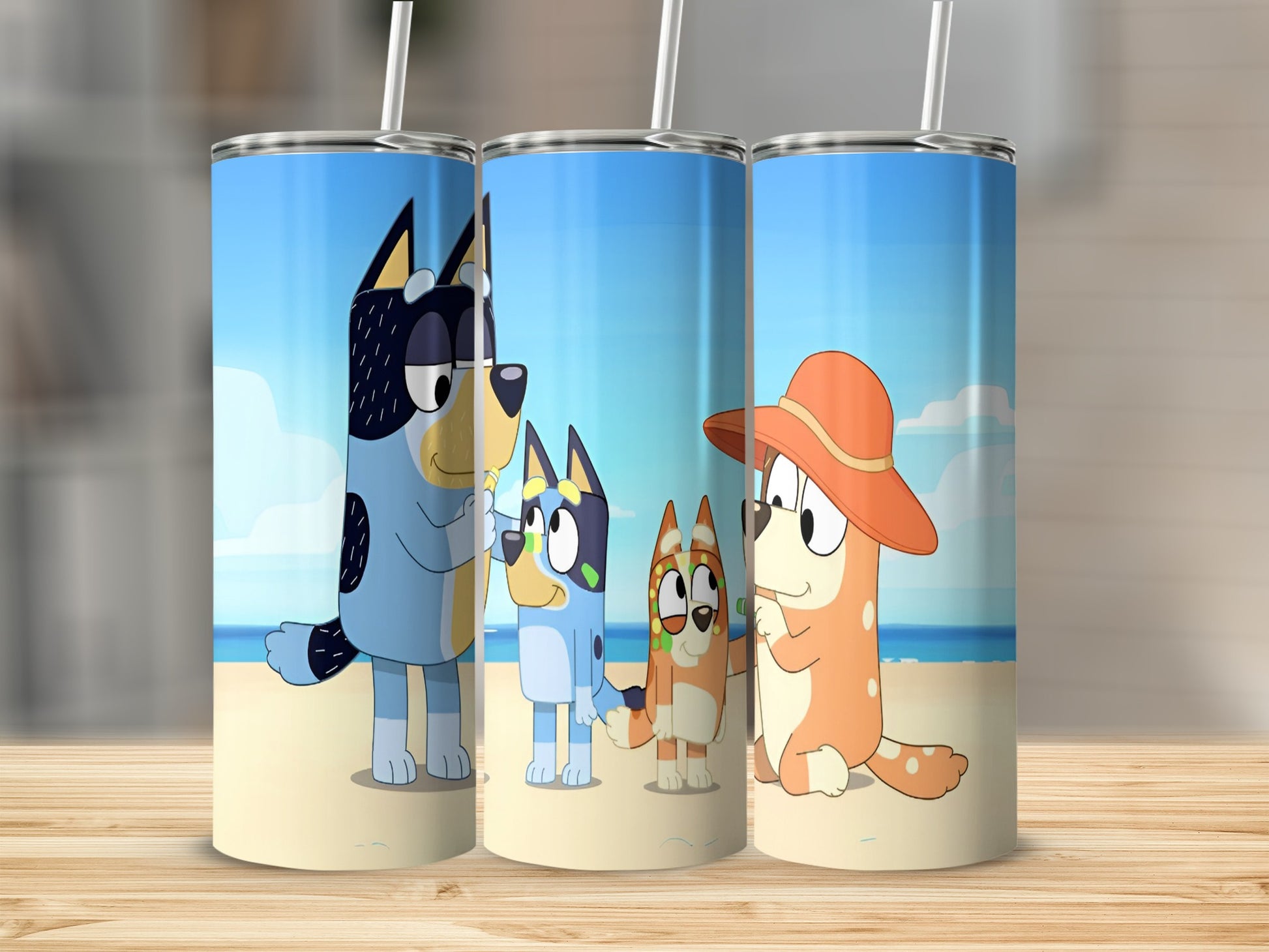 Bluey characters on a beach: Bandit, Bingo, Chilli, and Bluey.