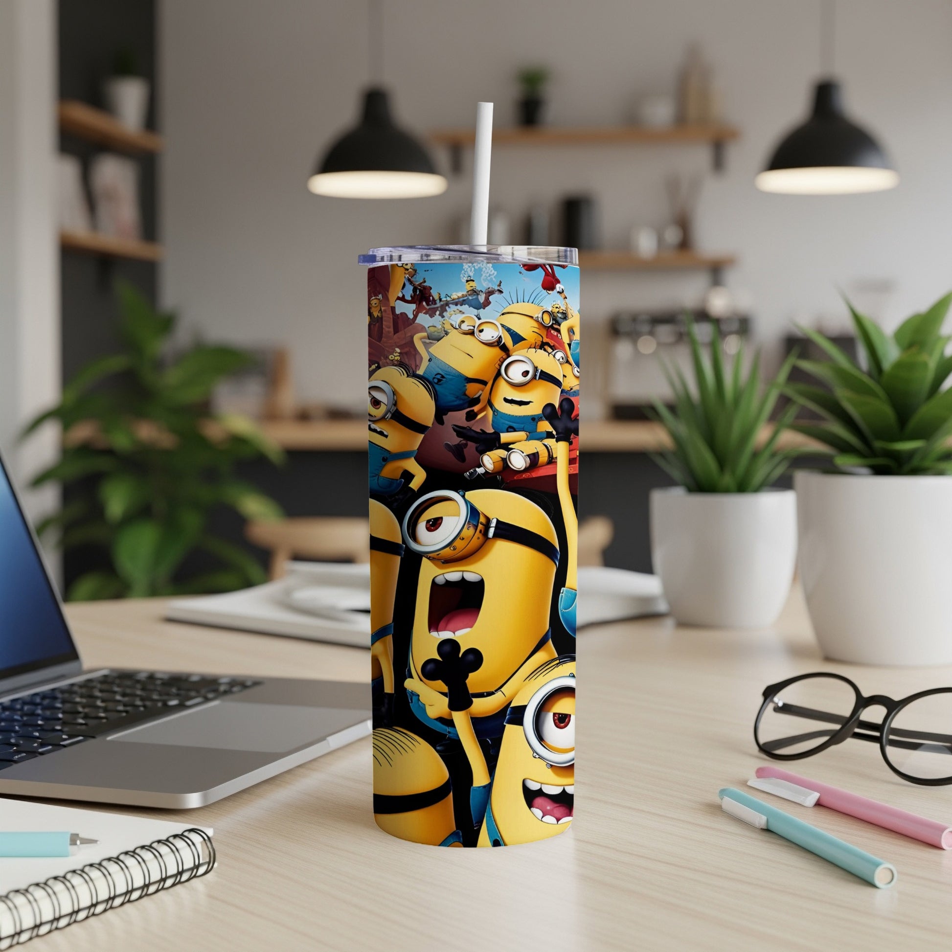 Tall tumbler with many cartoon Minions, some shouting, on a desk.