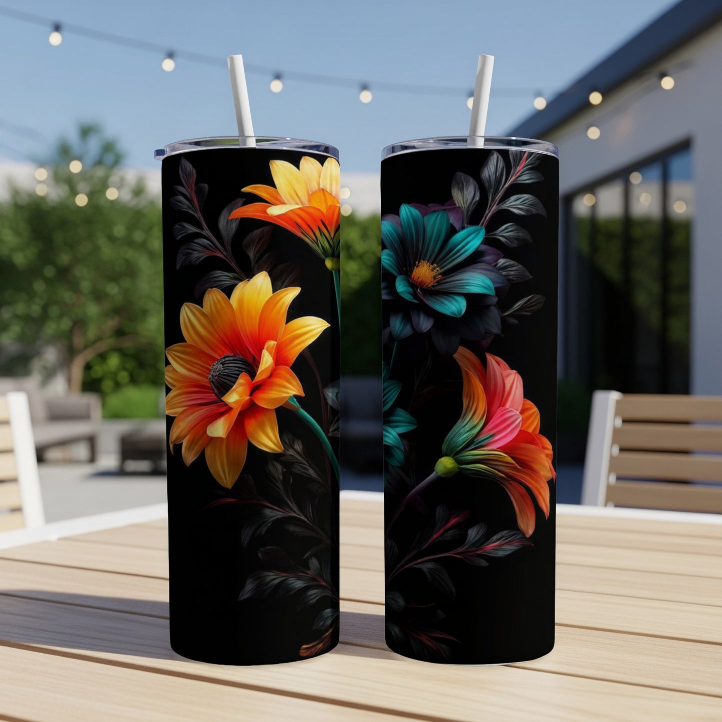 Two black tumblers with vibrant floral designs featuring orange, teal, and pink flowers.