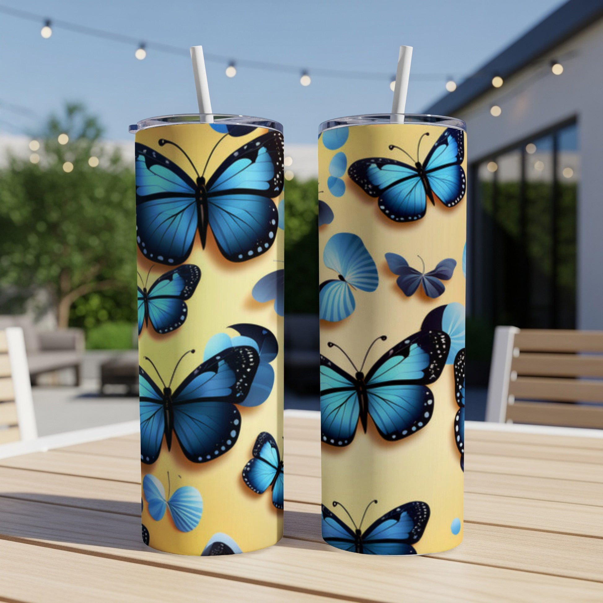 Two yellow tumblers adorned with blue butterflies and flower motifs.
