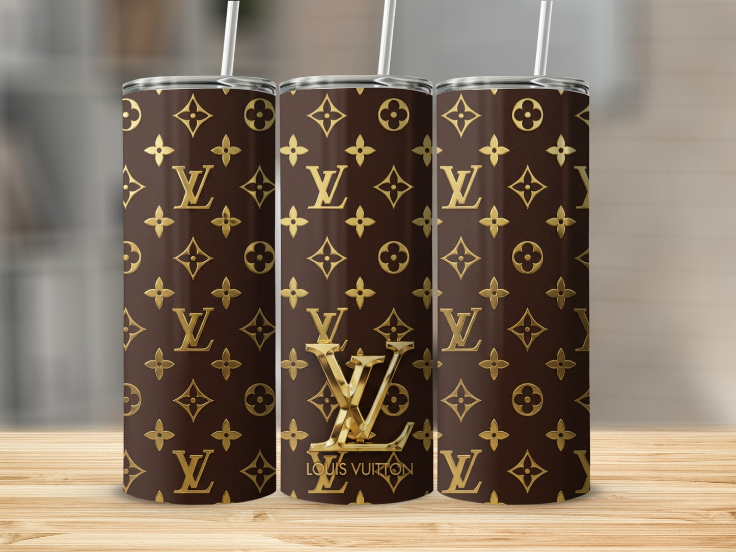 Trio of brown tumblers with gold Louis Vuitton monogram print and logo.