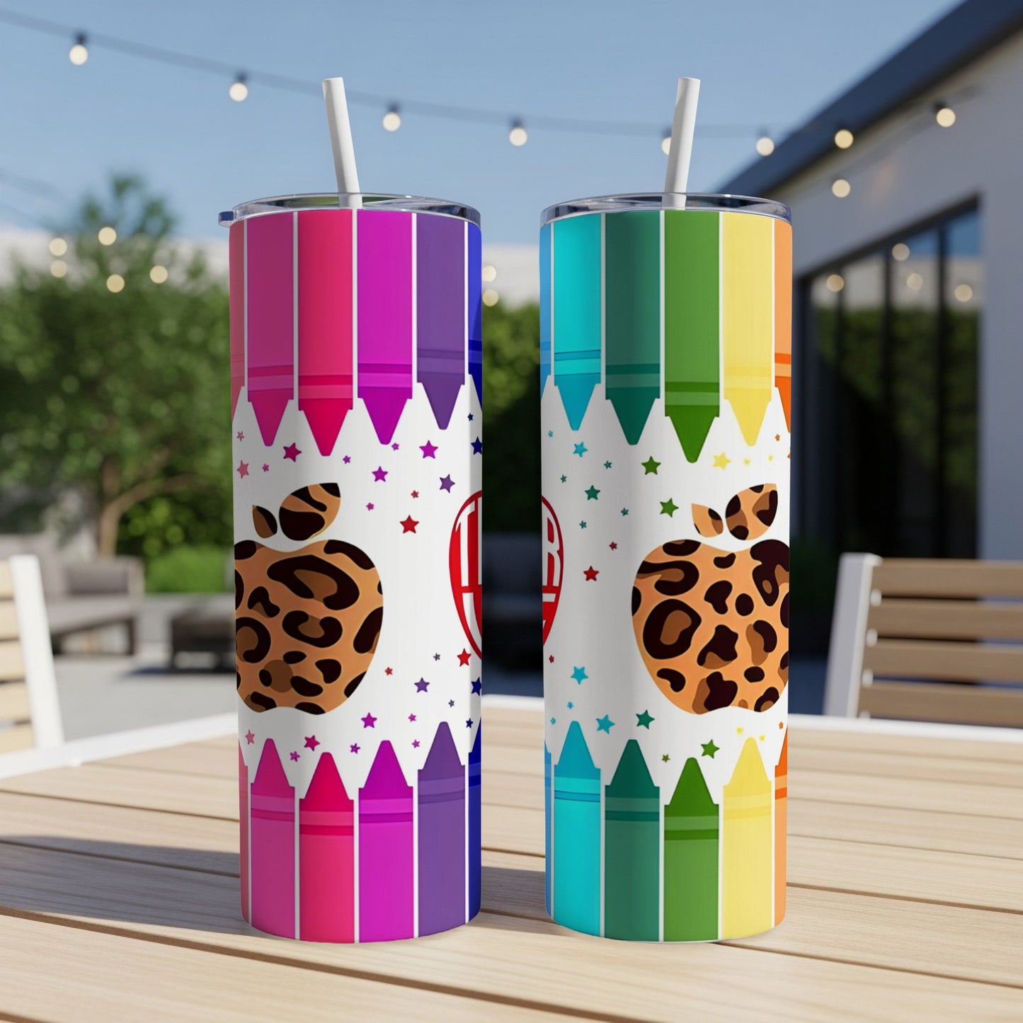Two tumblers with crayon and leopard print designs on a table.