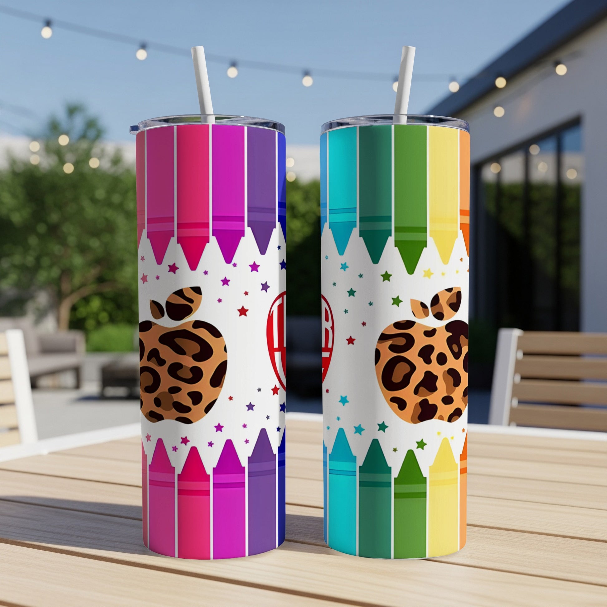 Two tumblers with crayon and leopard print designs on a table.