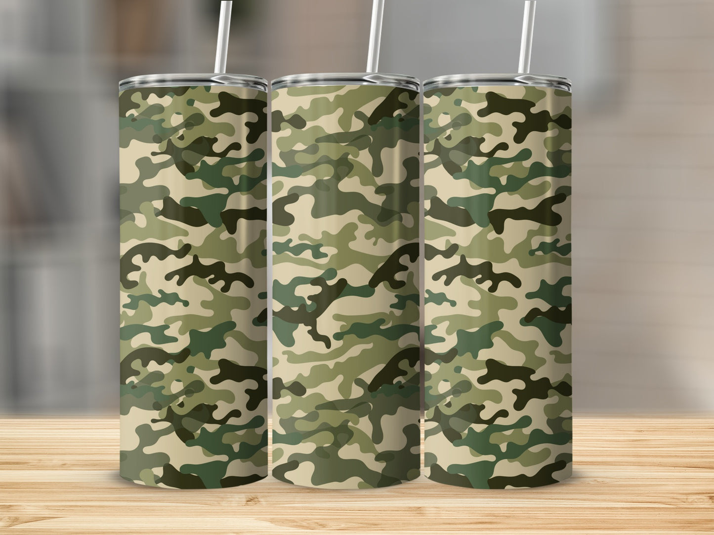 Three tumblers with camouflage pattern stand on a wooden surface.