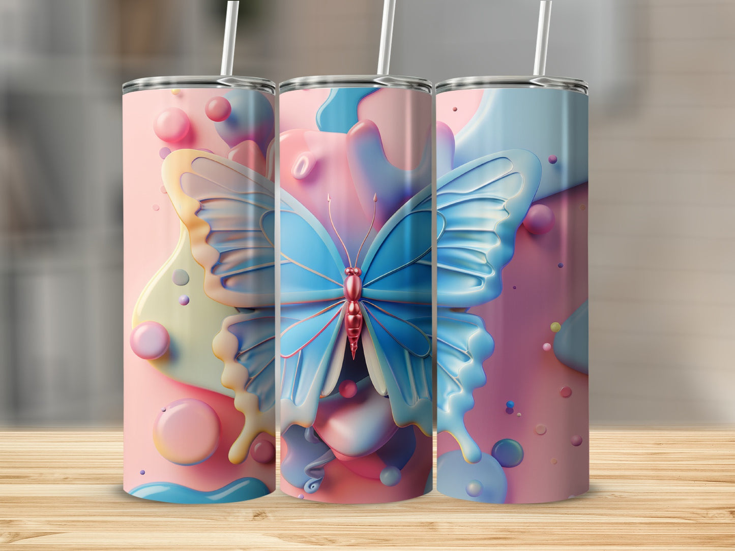 Three tall tumblers featuring a blue butterfly design on a pink and blue pastel background.