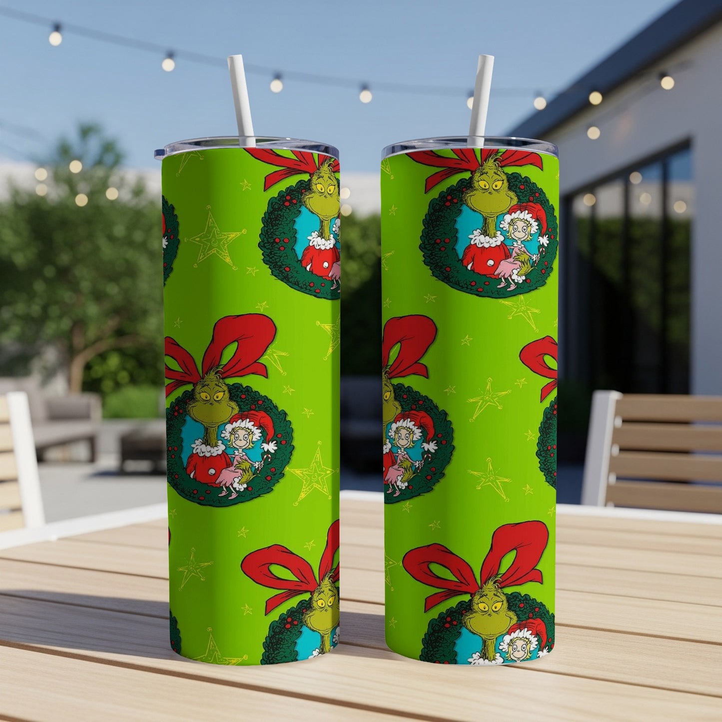 Green Grinch Christmas tumbler with wreath and red bow pattern.